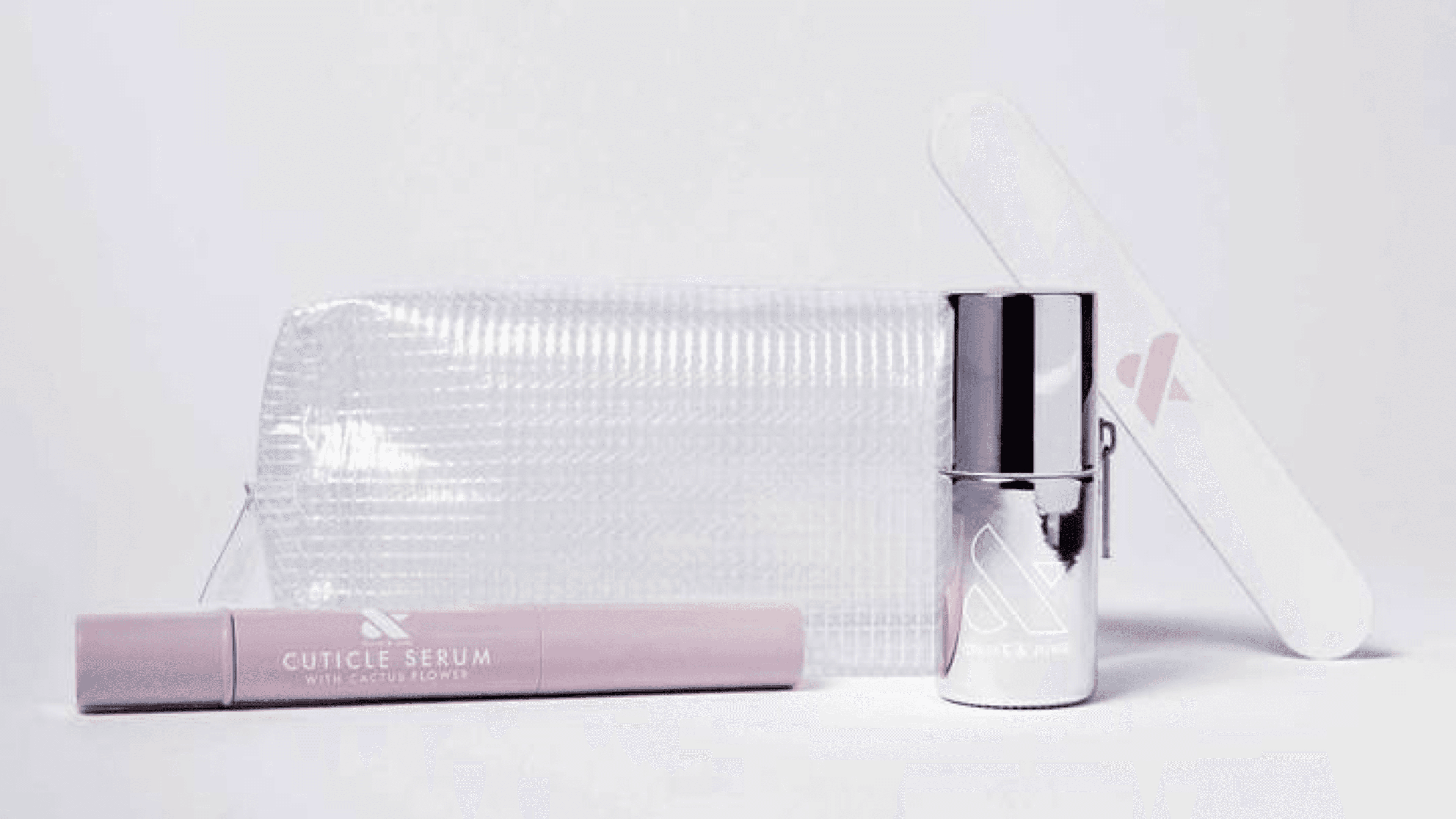 nail kit with a cuticle serum, nail file, and top coat protector