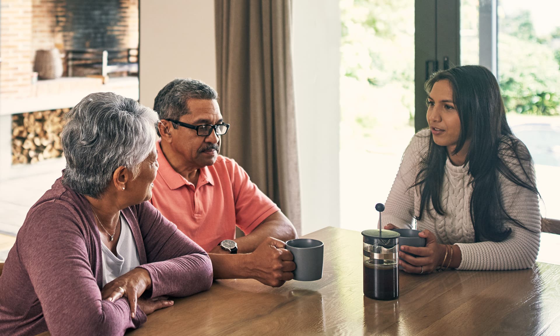 Woman talking to older parents