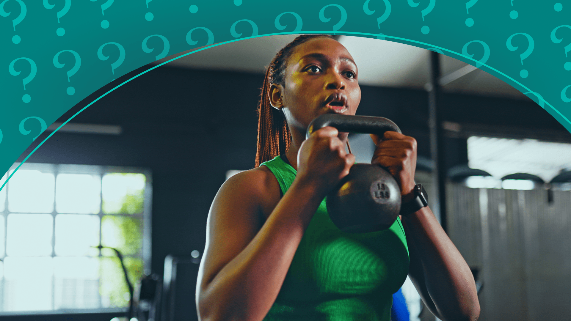 A woman lifting a kettlebell at the gym