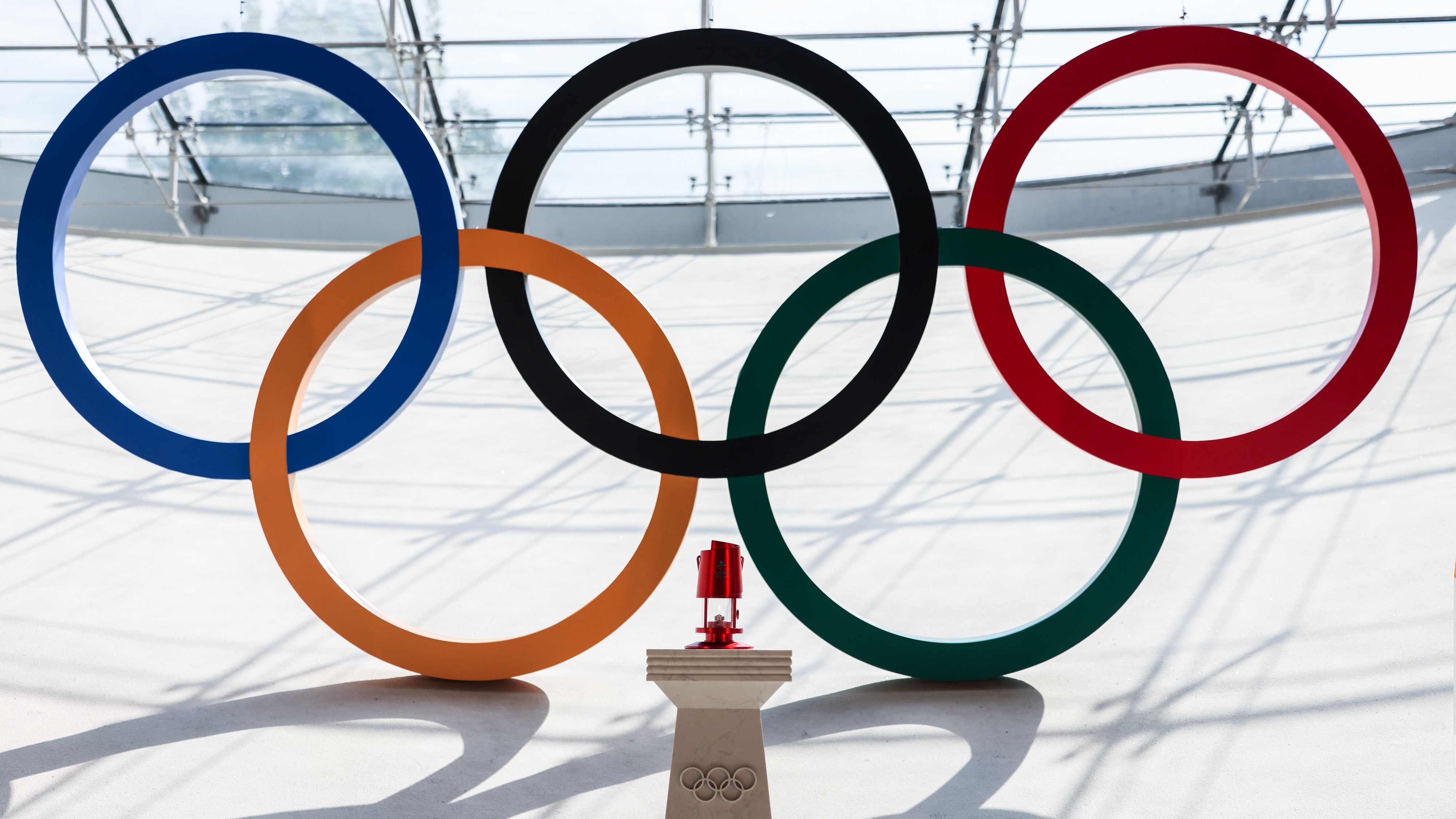 The Olympic flame is seen in a lantern during