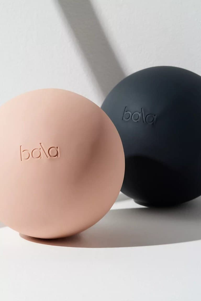 a pink and a black bala pilates ball, best at-home pilates equipment