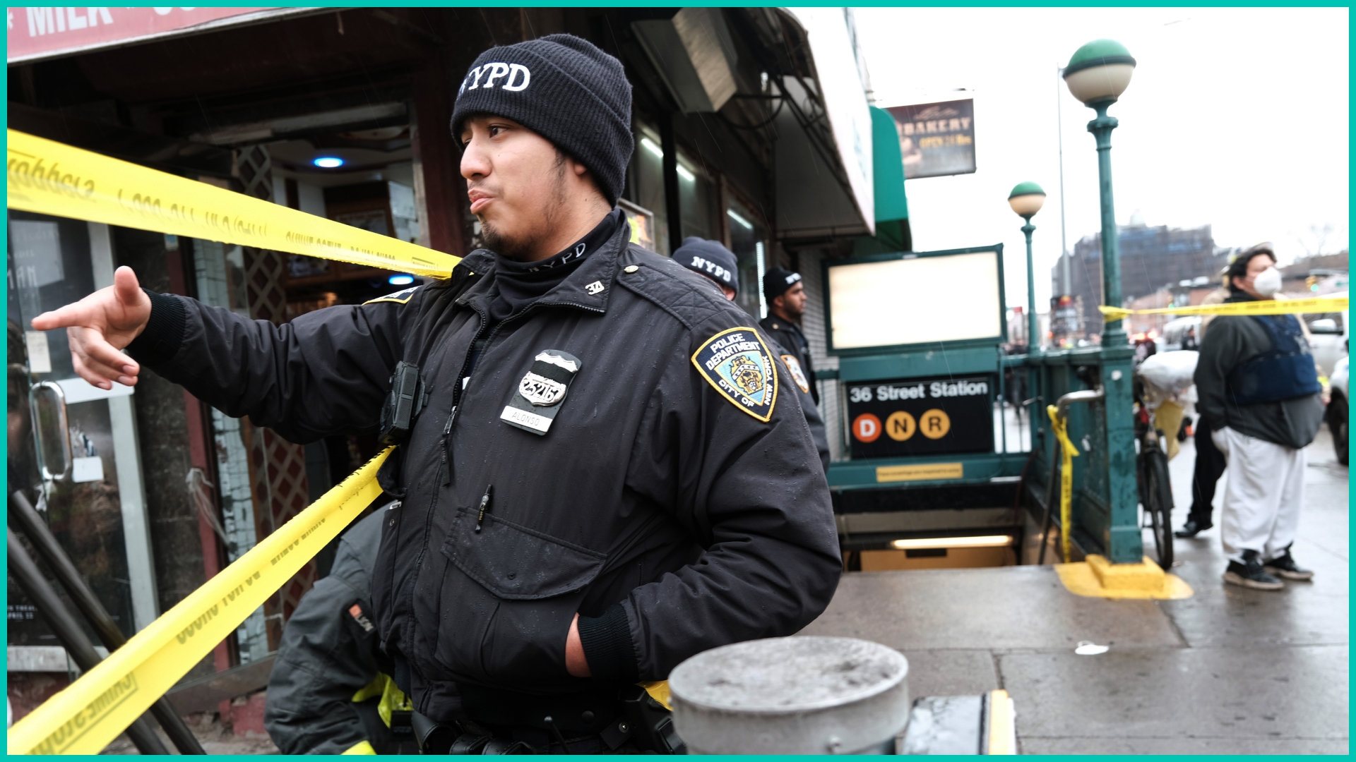Police and emergency responders gather at the site of a reported shooting of multiple people outside of the 36 St subway station