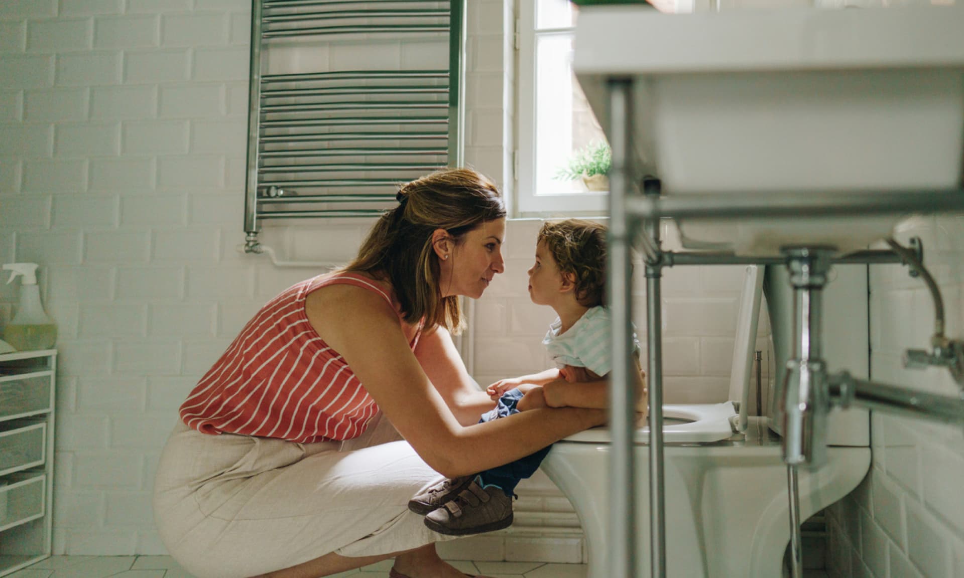 mom holding baby in bathrooom