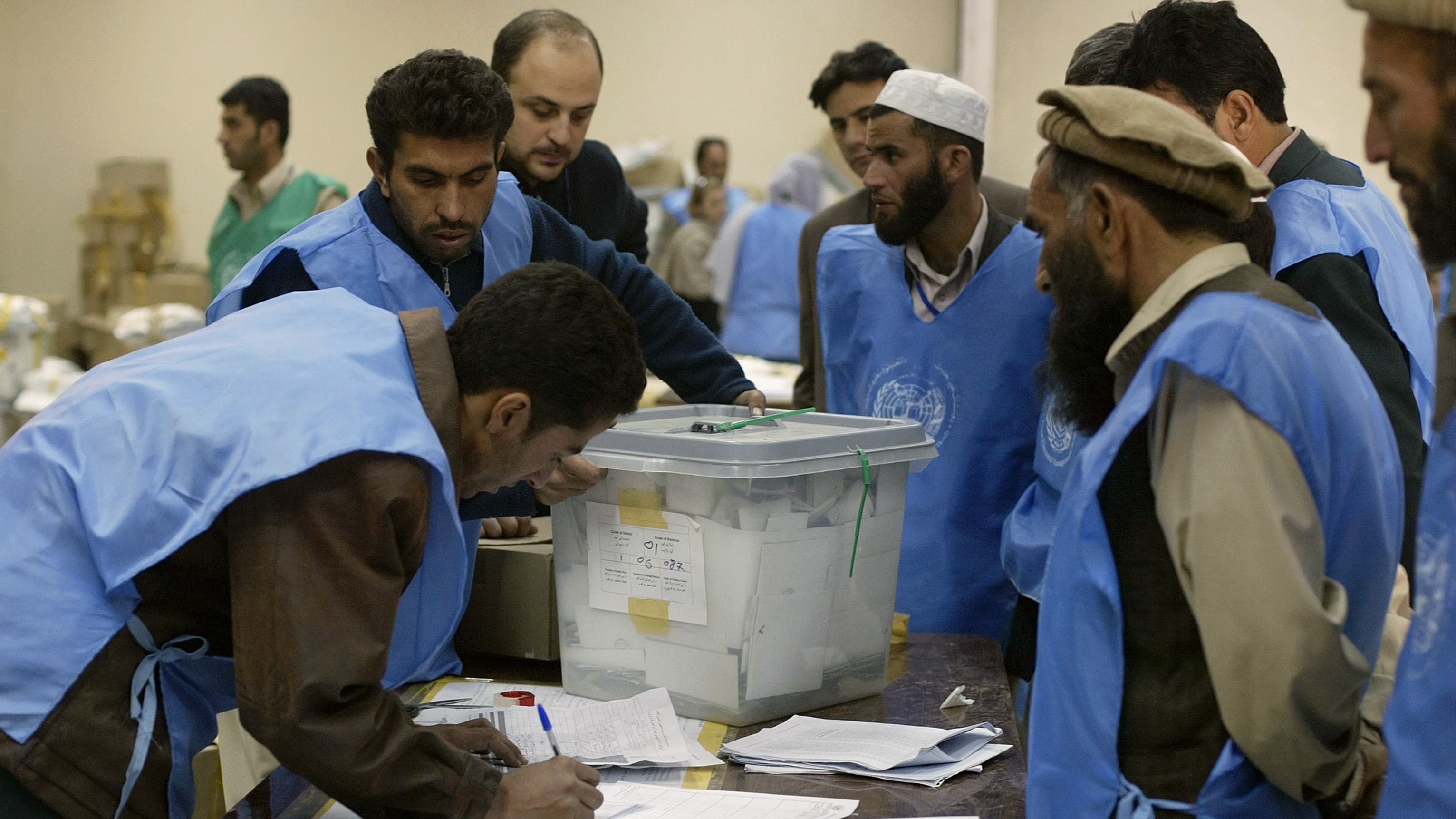 Afghans and United Nations officials record votes from ballot boxes received from Kabul polling stations after Afghanistan's first ever presidential elections, on October 10, 2004 in Kabul, Afghanistan.
