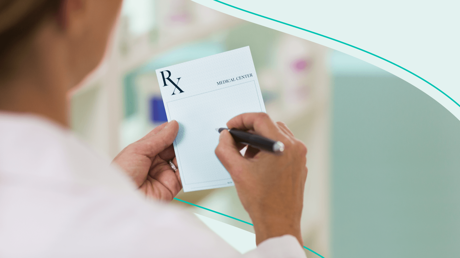 A physician holds a blank prescription pad