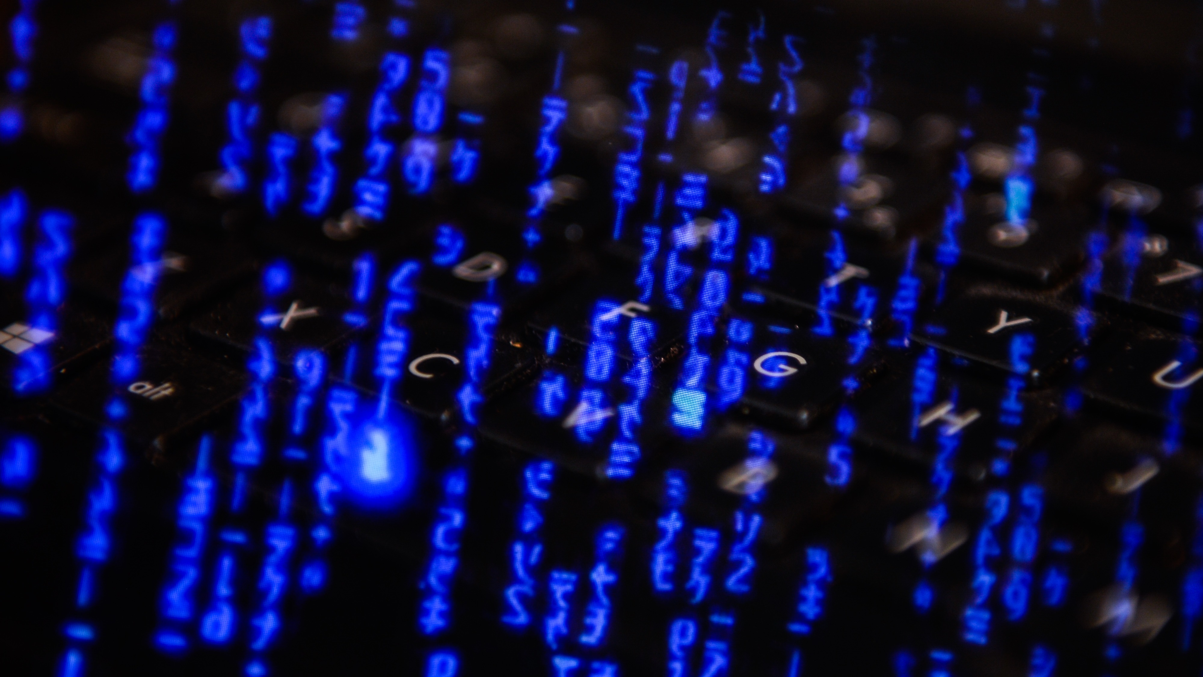 Hackers code and a computer keyboard.