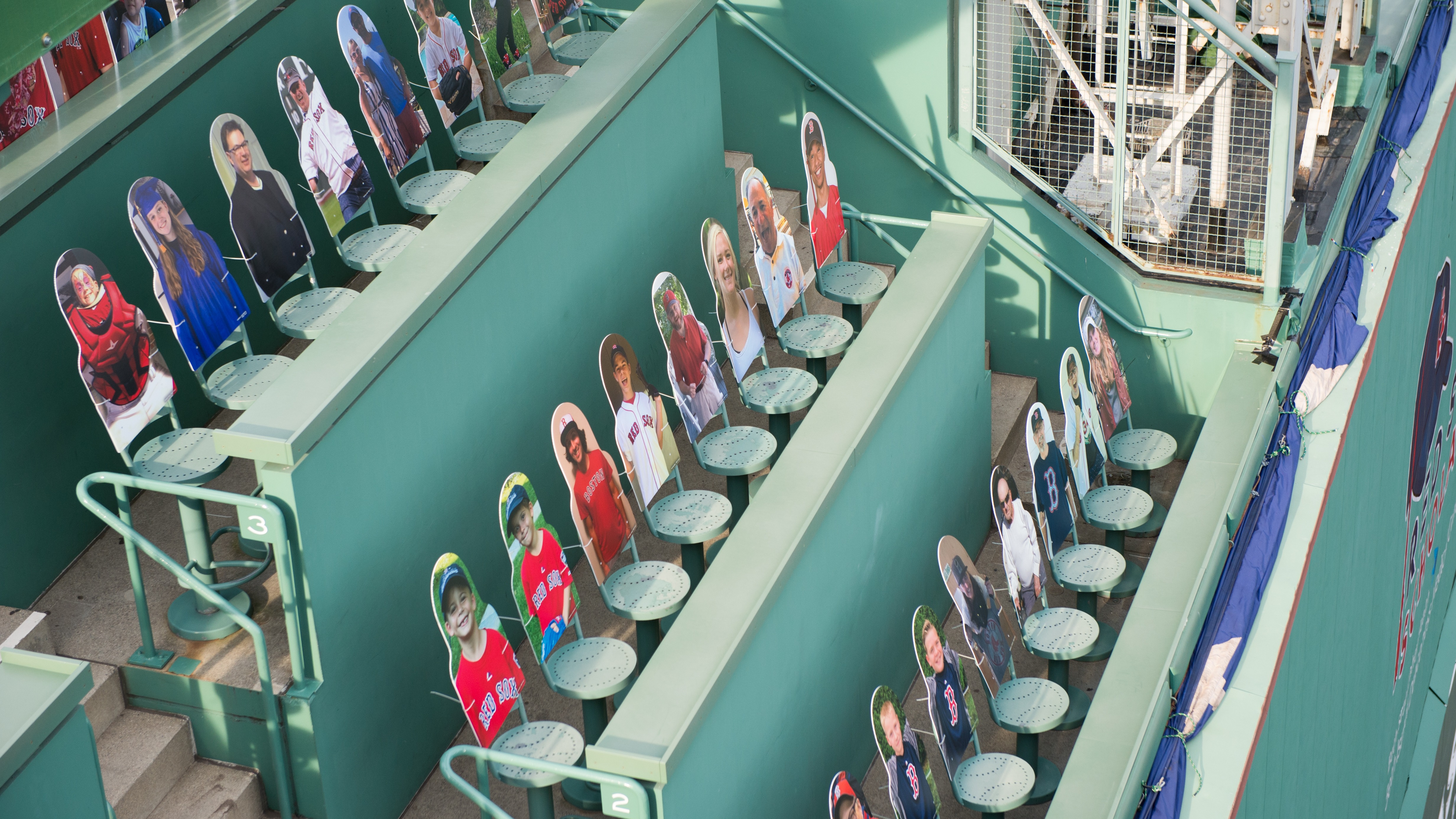 Cardboard cut outs of fans sitting in the Green Monster on Opening Day at Fenway Park