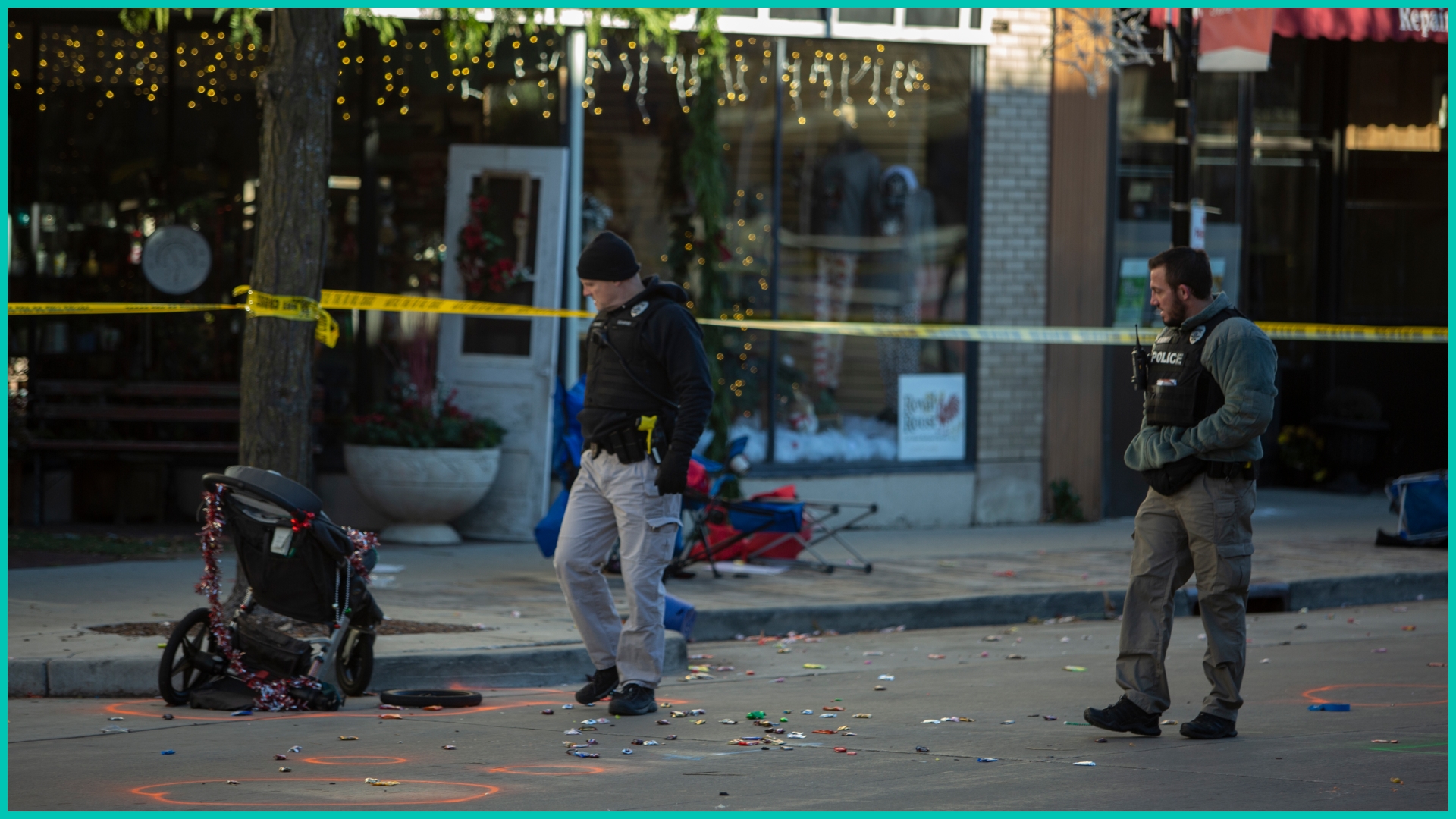Police canvas debris left following a driver plowing into the Christmas parade on Main Street in downtown November 22, 2021 in Waukesha, Wisconsin