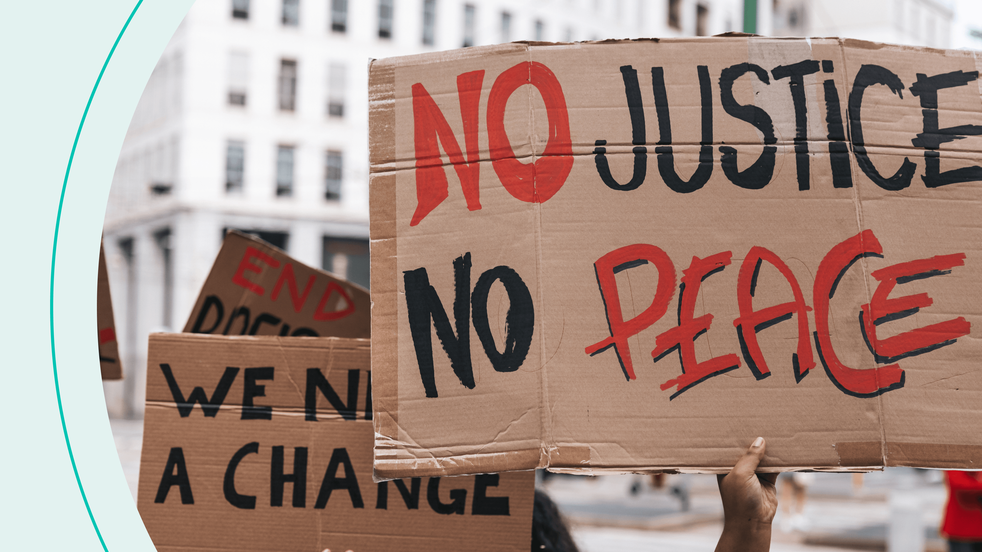 Protestors holding hand-made signs on cardboards and marching together in the city streets in downtown.