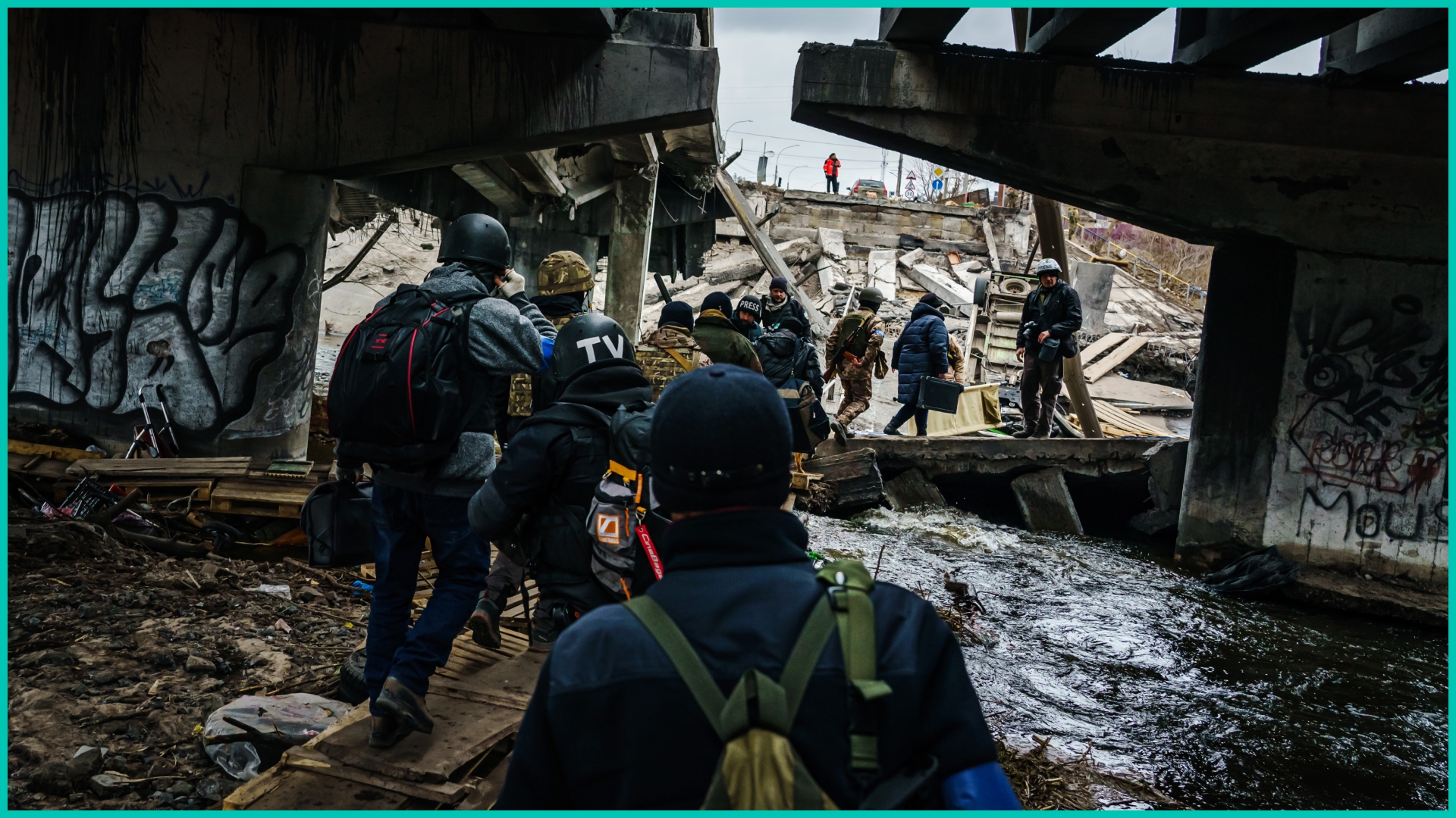 People walking by wreckage in Ukraine