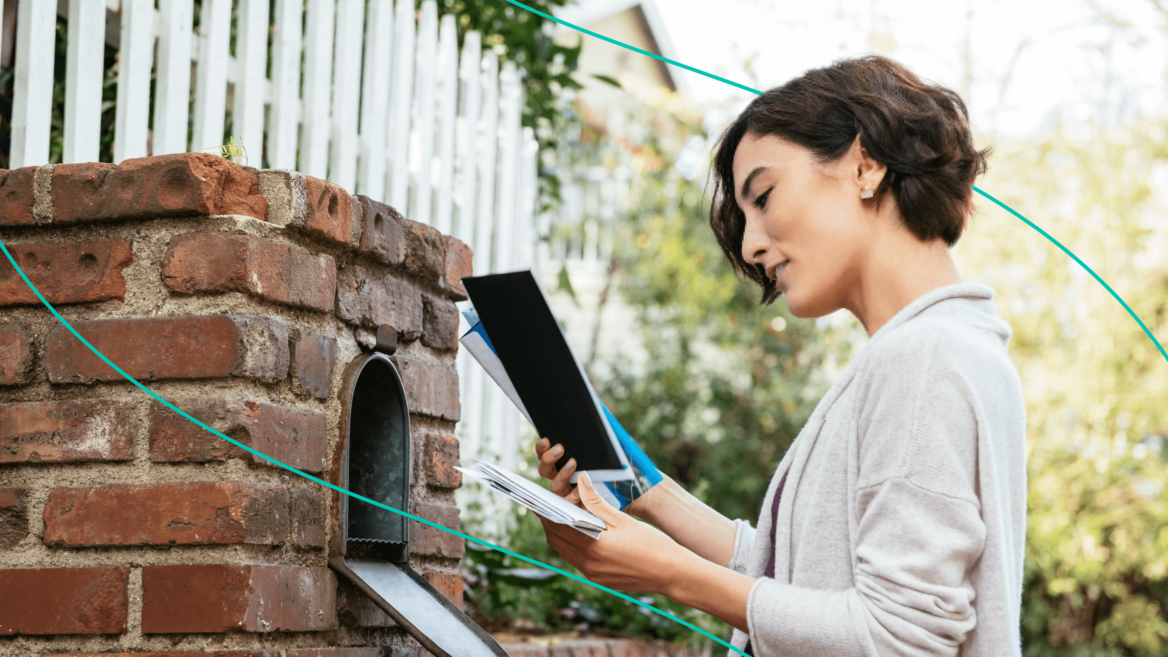 A woman going through her mail at a mailbox