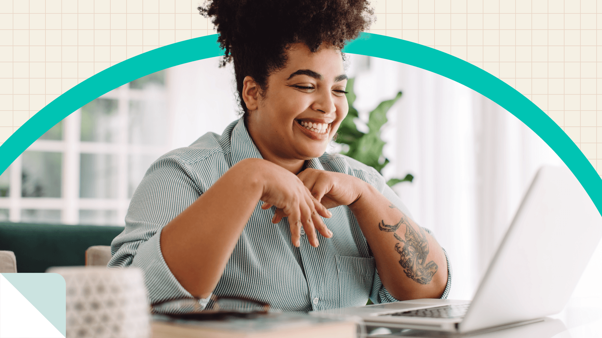 woman smiling at laptop screen