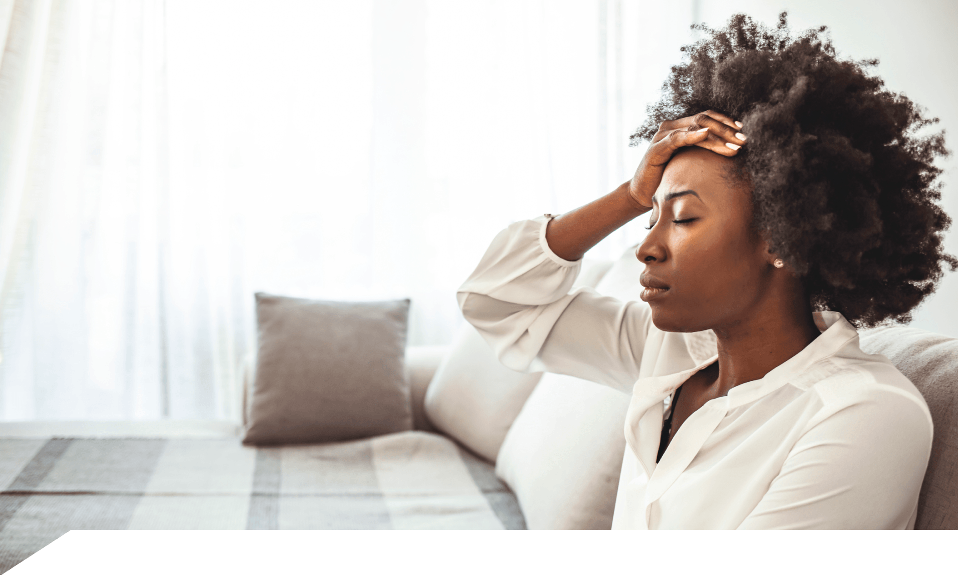 A woman with her hand on her forehead looking distressed