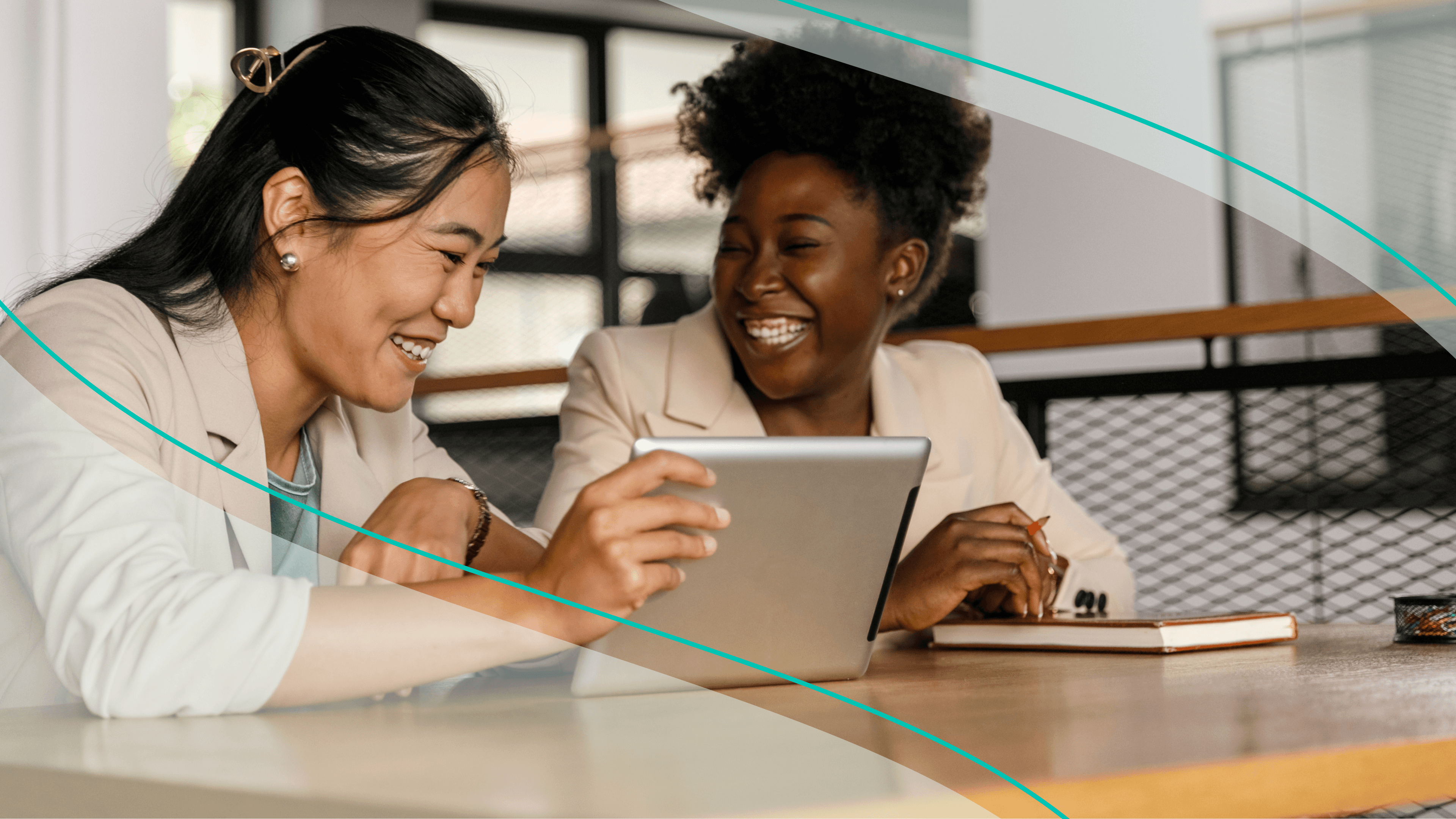 Women laughing over a laptop