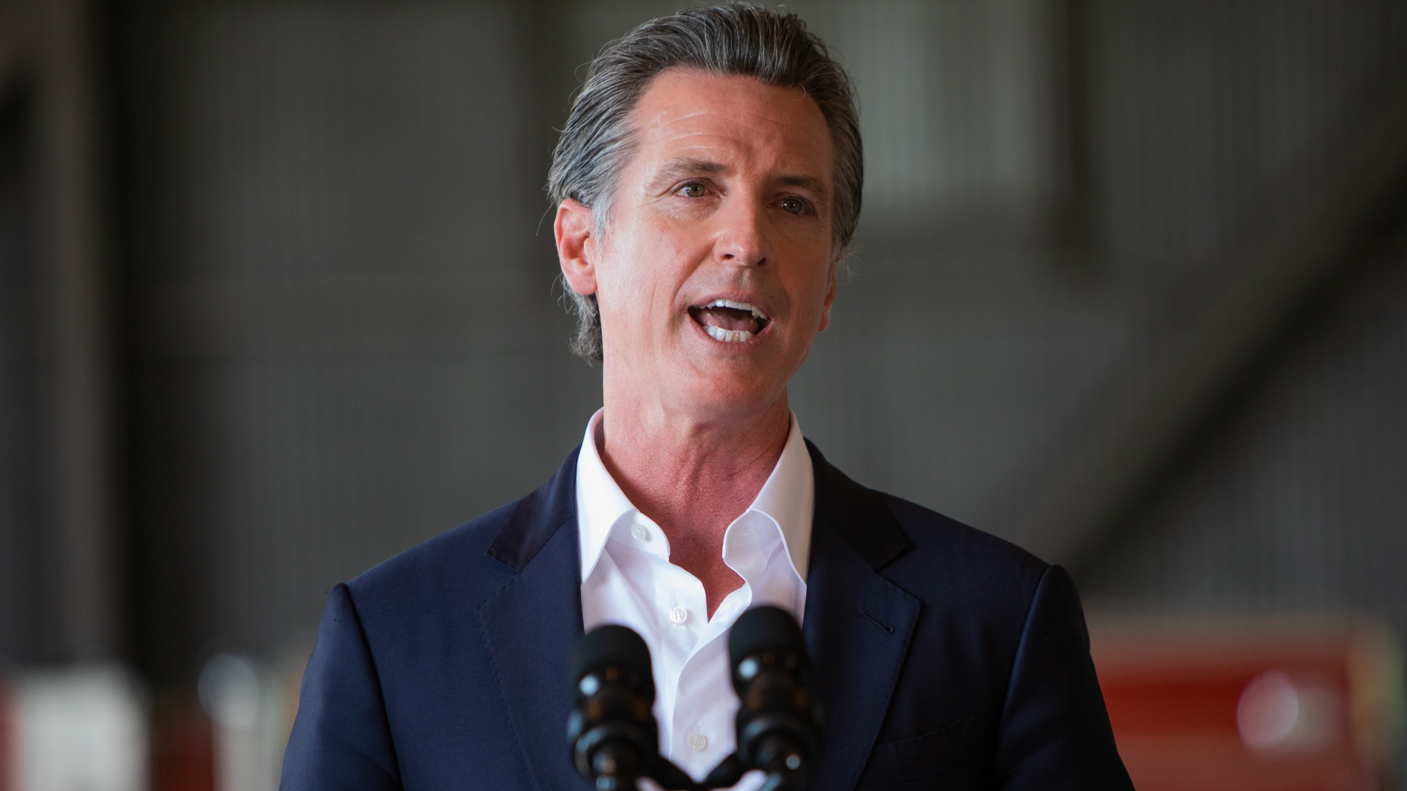 Governor Gavin Newsom speaks alongside President Joe Biden at a press conference held at Mather airport in Sacramento