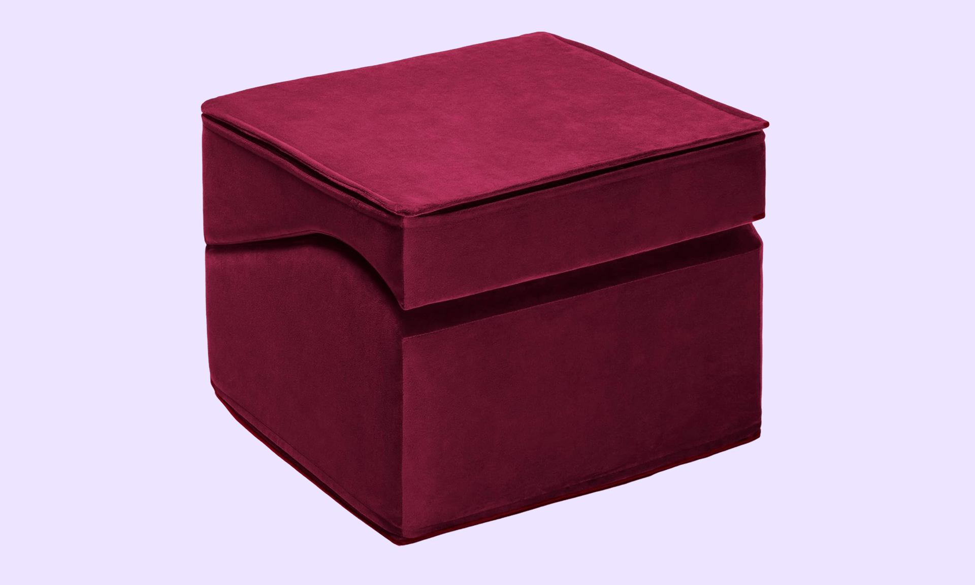 Maroon velvet ottoman on light purple background