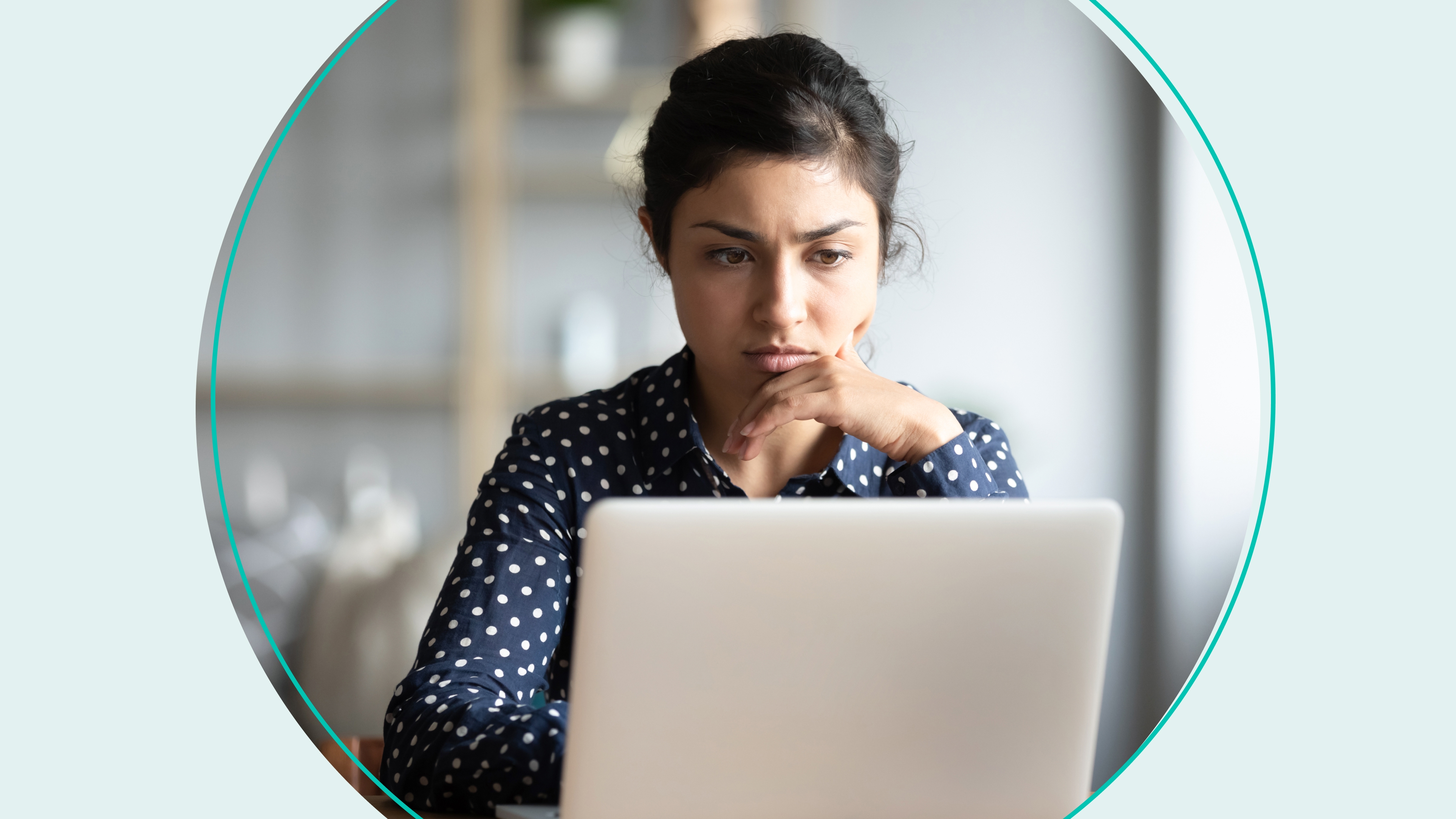 woman looking with concern at laptop
