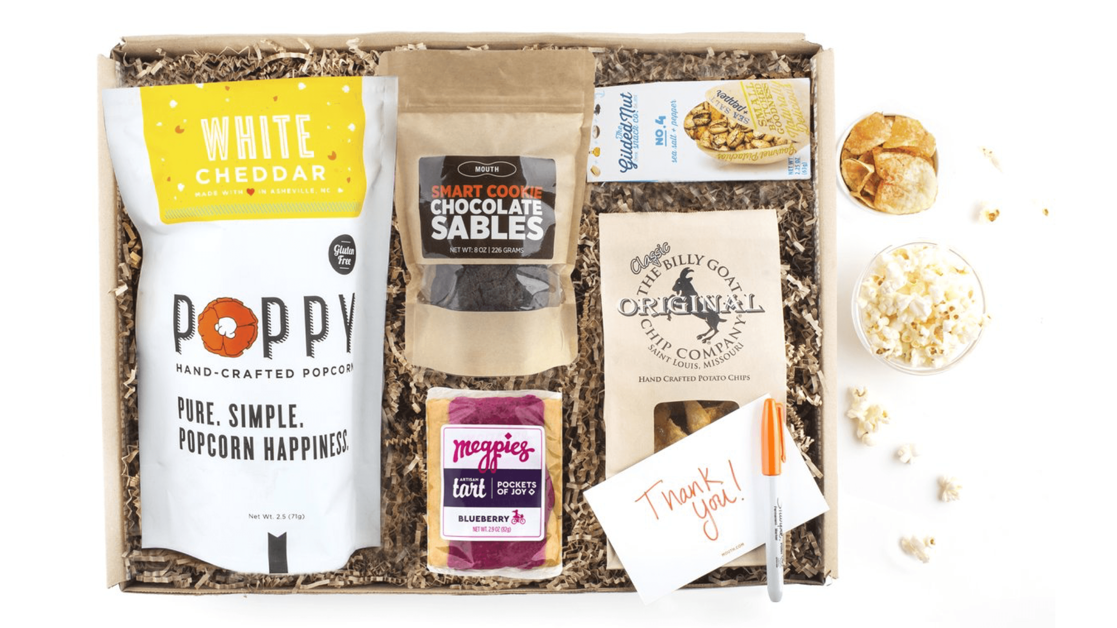 delicious snack pack with popcorn, pretzels, and chocolates