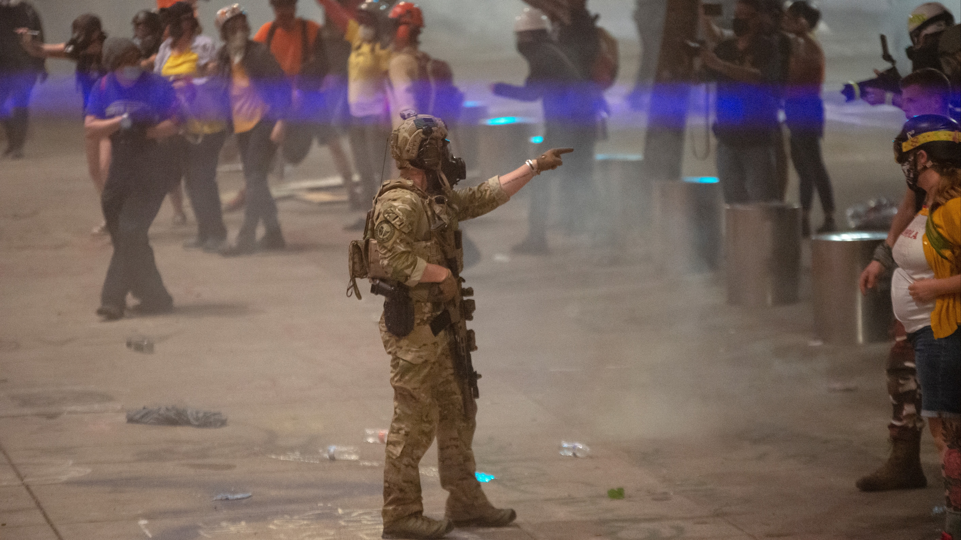 A federal officer points to a protester in Portland