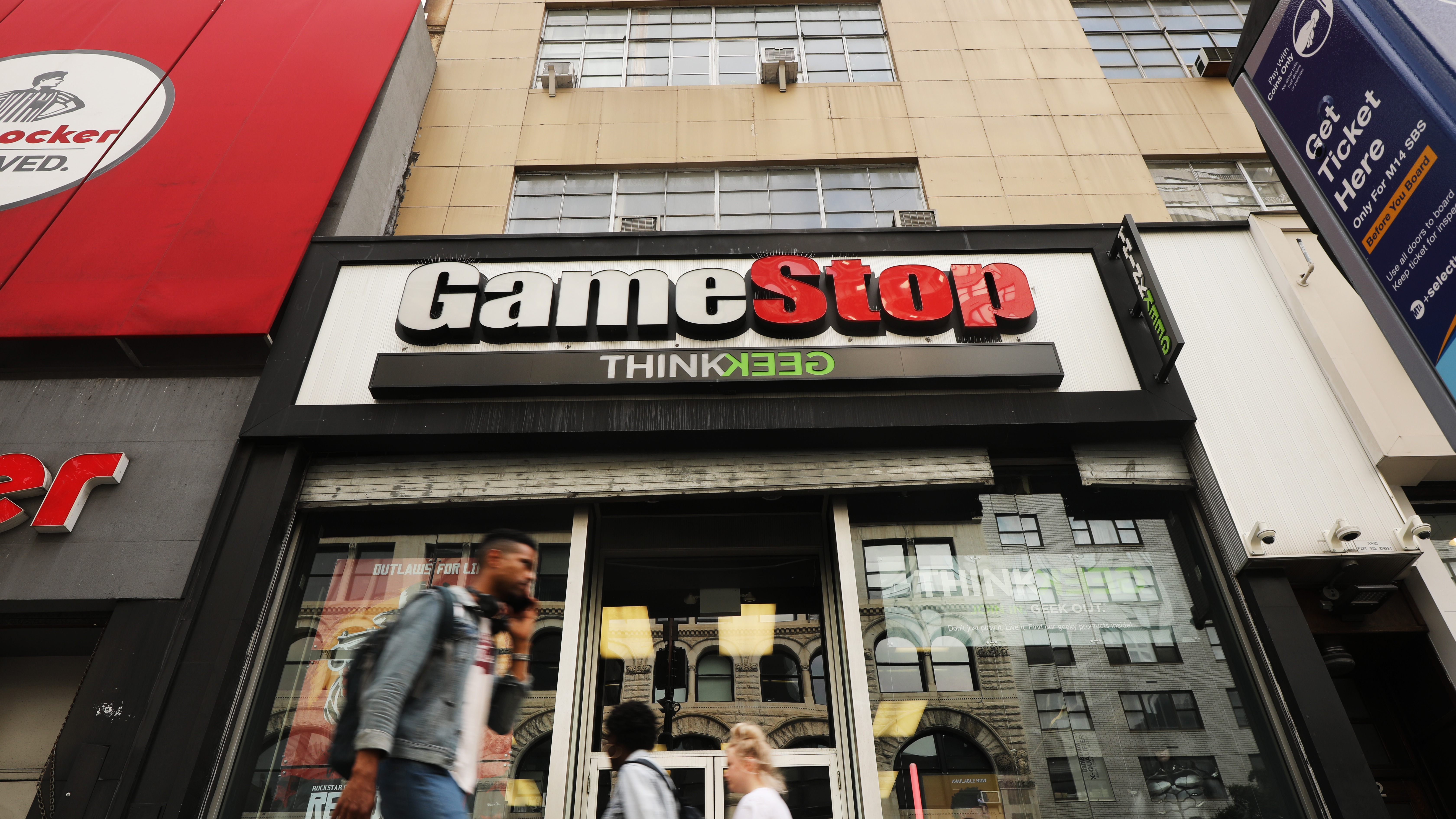 People pass a GameStop store in lower Manhattan on September 16, 2019 in New York City.