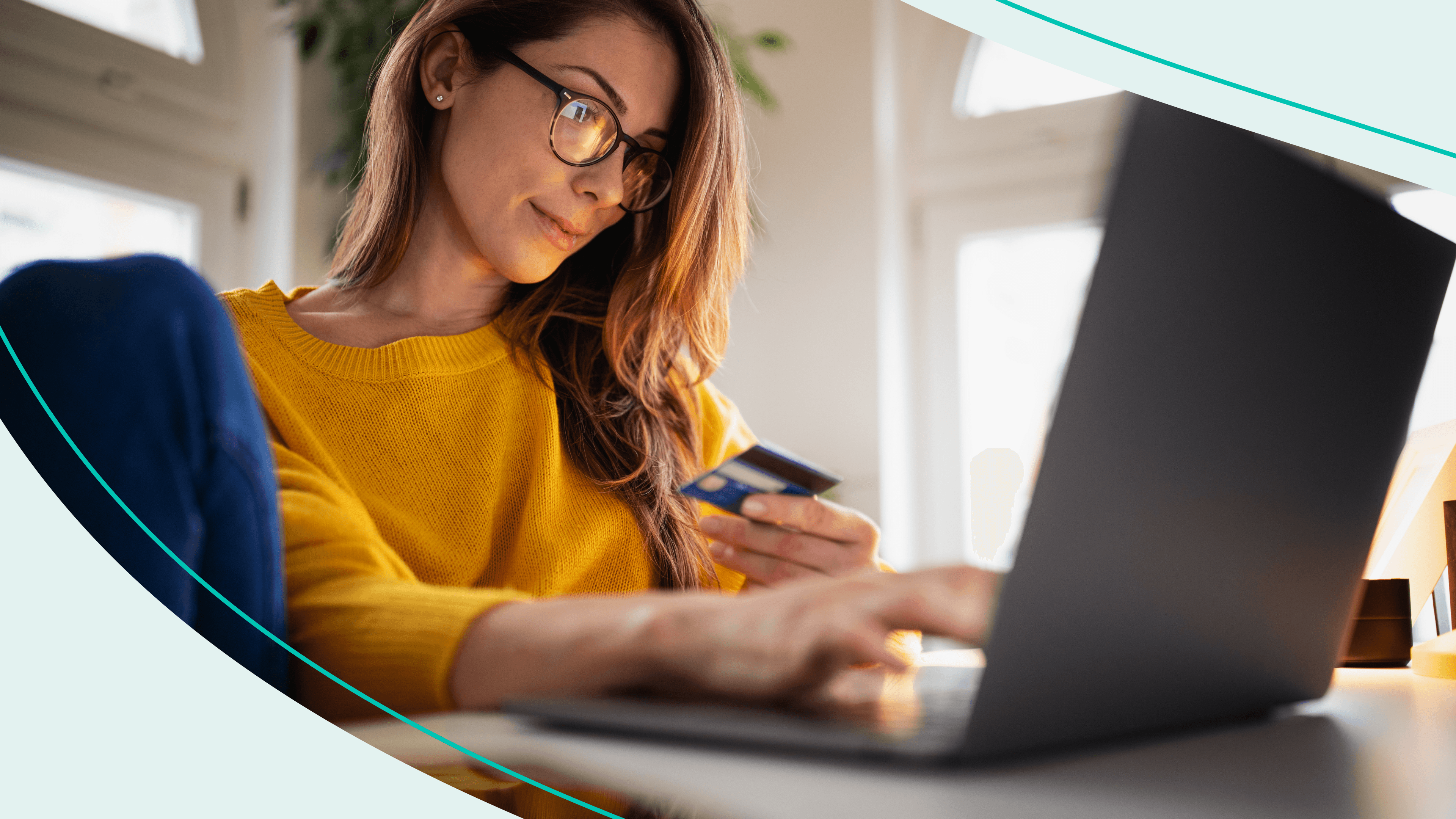 woman looking up credit card information on laptop