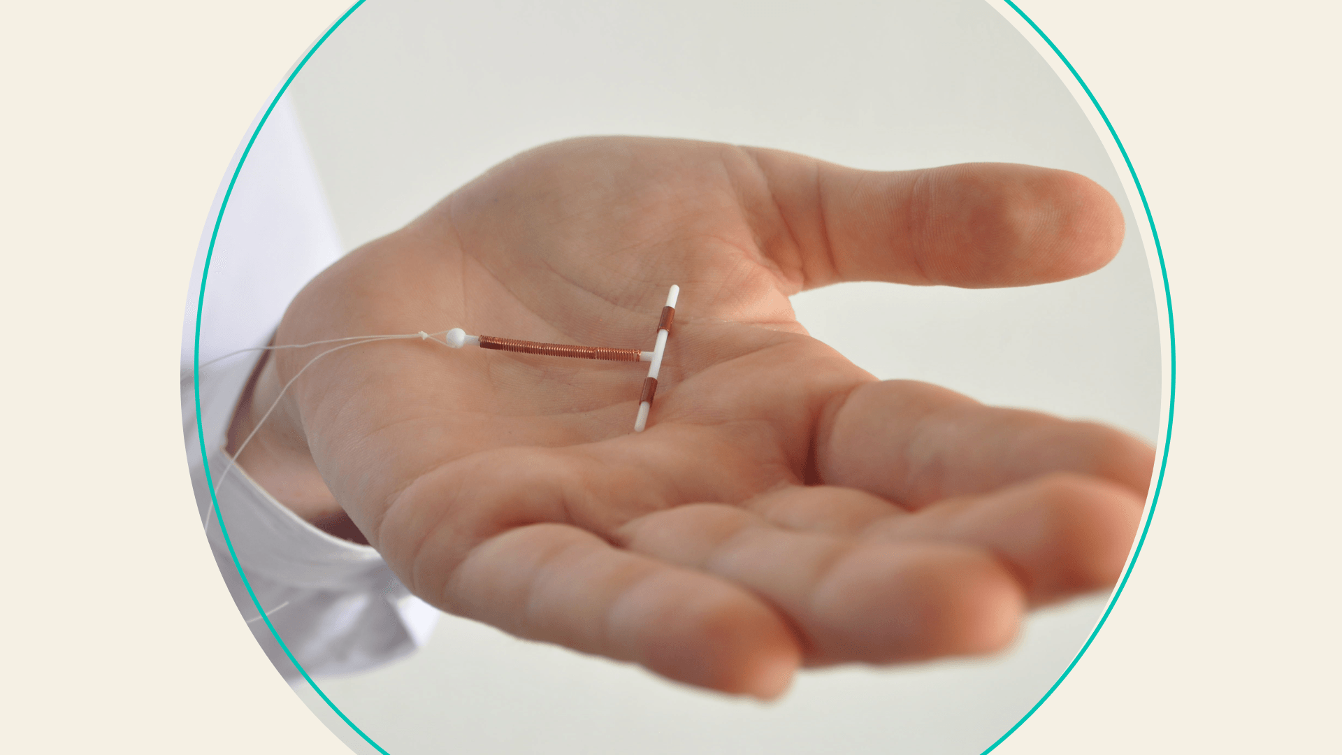 A doctor holding a copper IUD in their palm