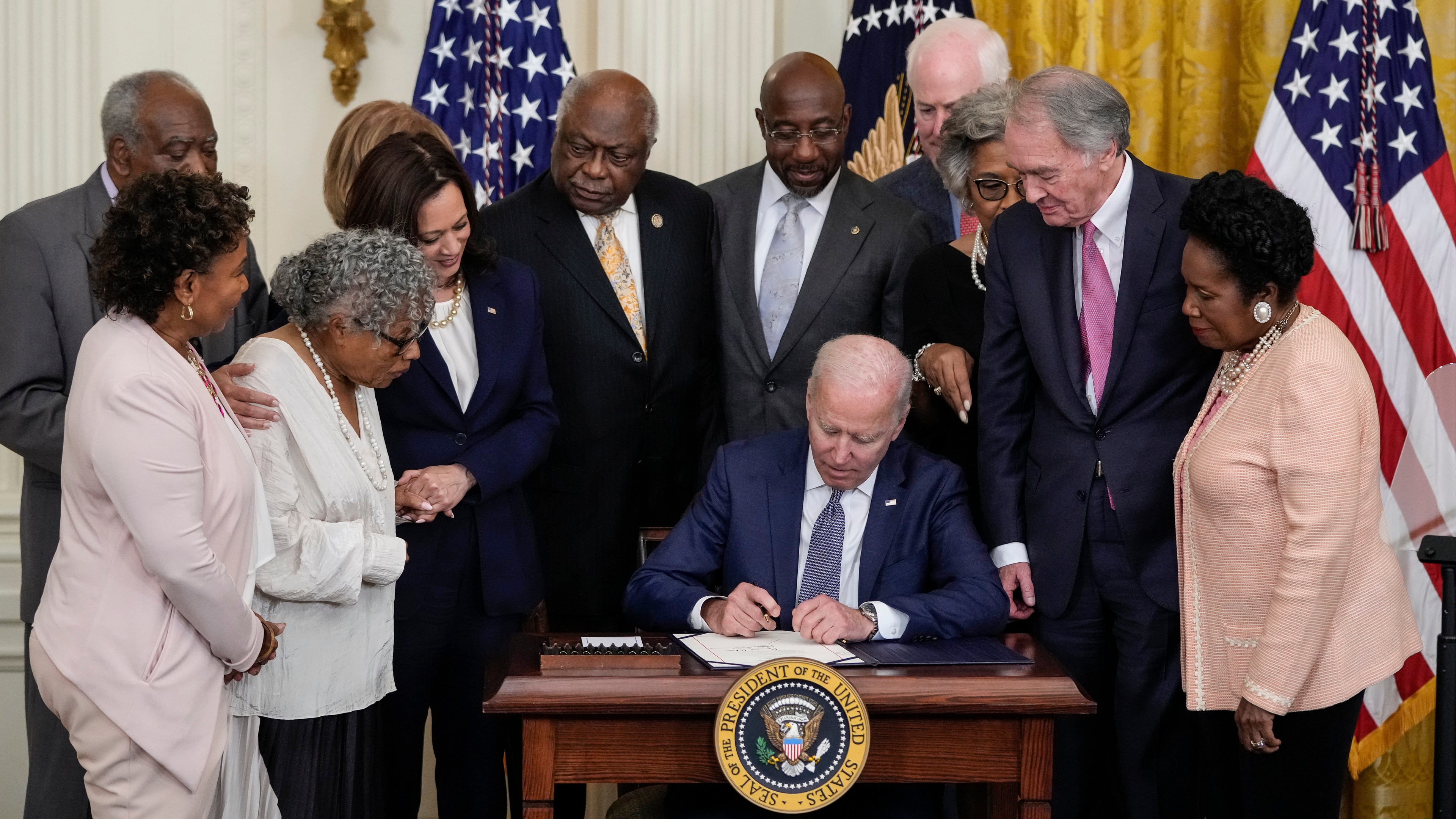 President Joe Biden signs the Juneteenth National Independence Day Act into law in the East Room of the White House