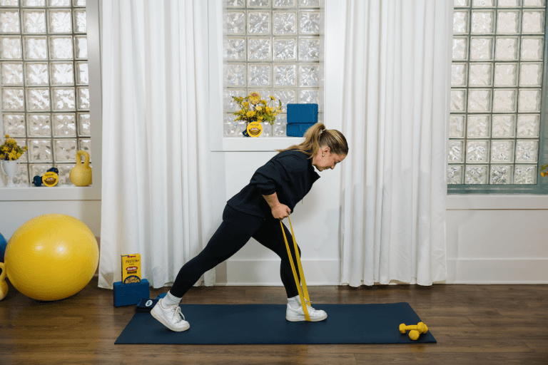 Shawn Johnson East demonstrating banded row as part of at-home workout
