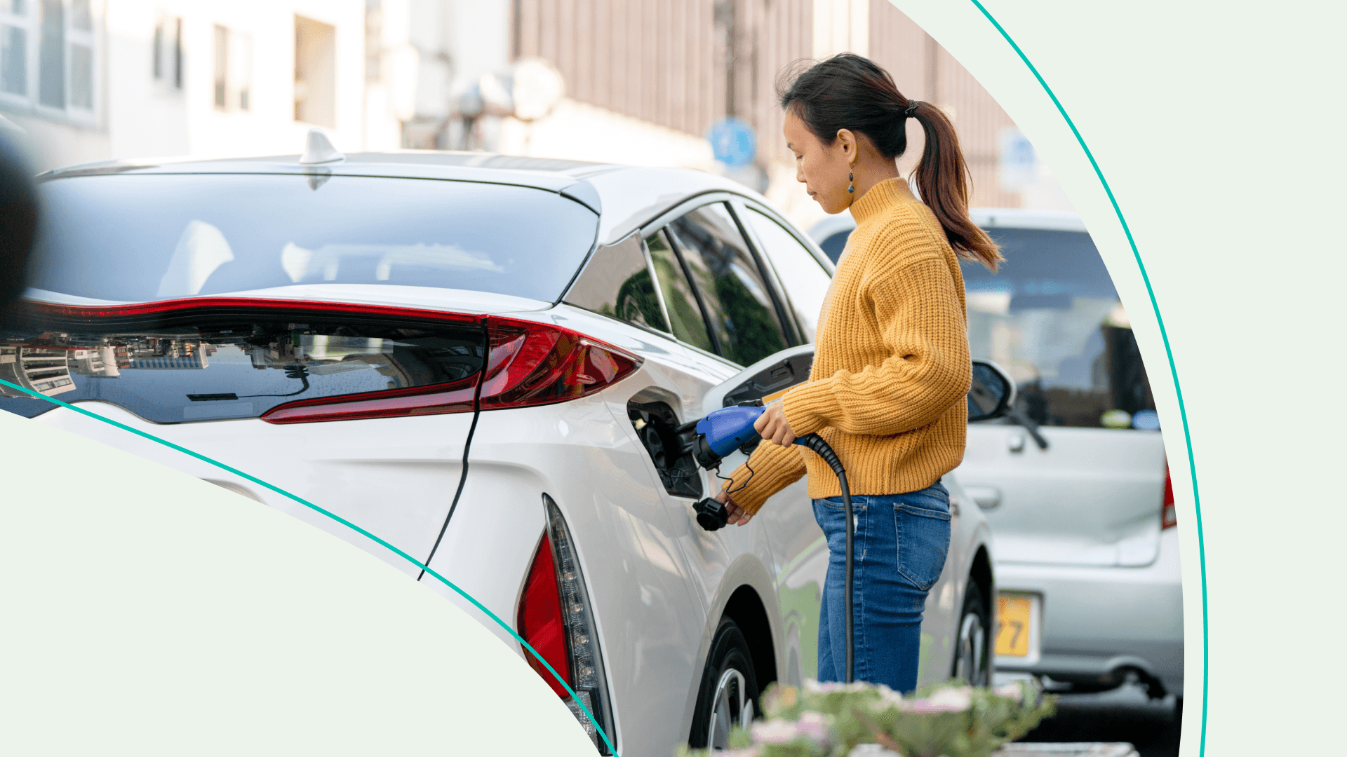 A woman charging an electric car