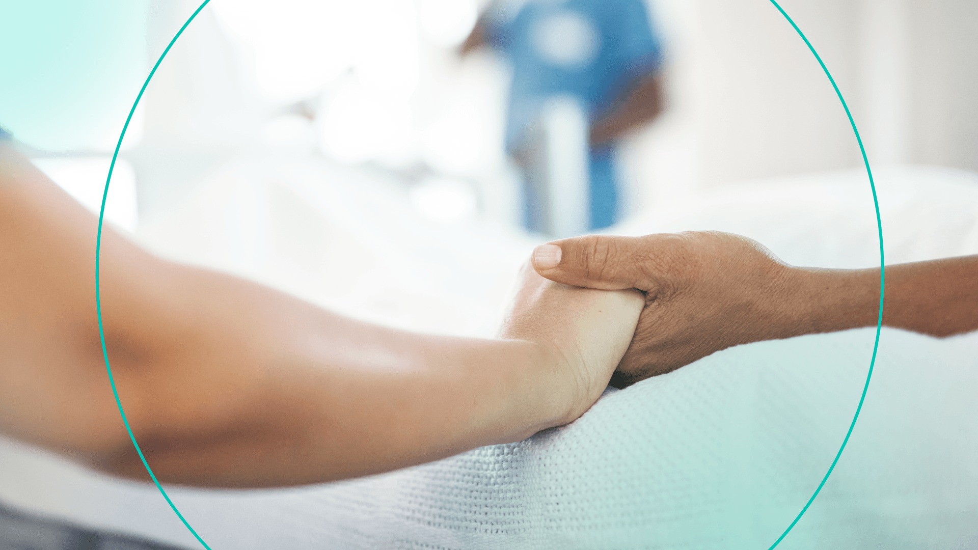 two hands holding in a hospital bed