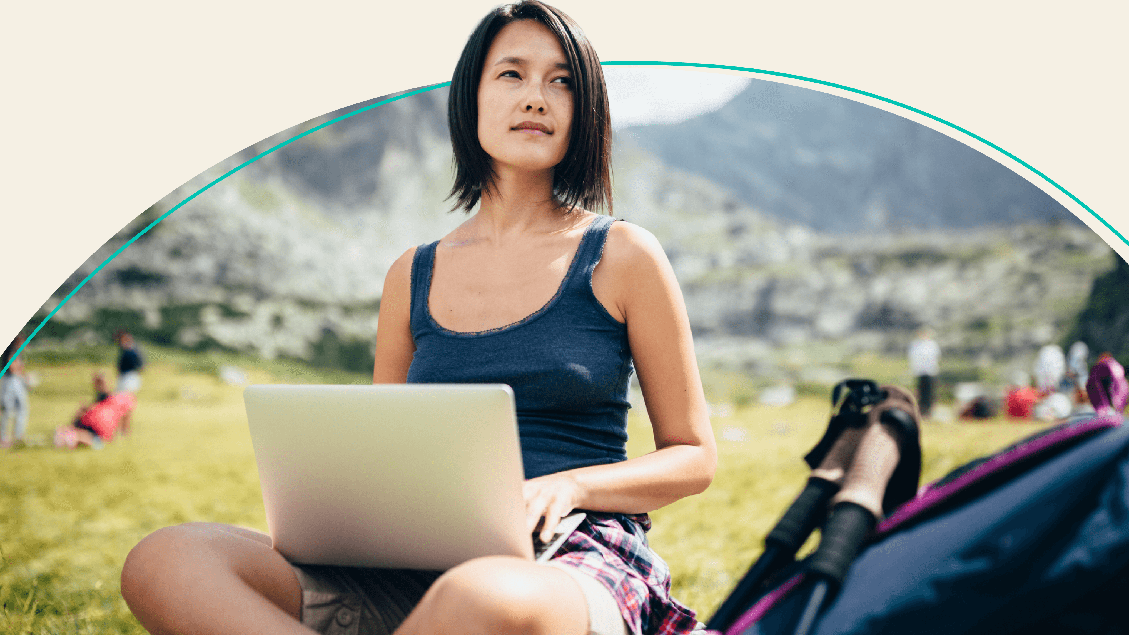 A woman holding a laptop while working outside