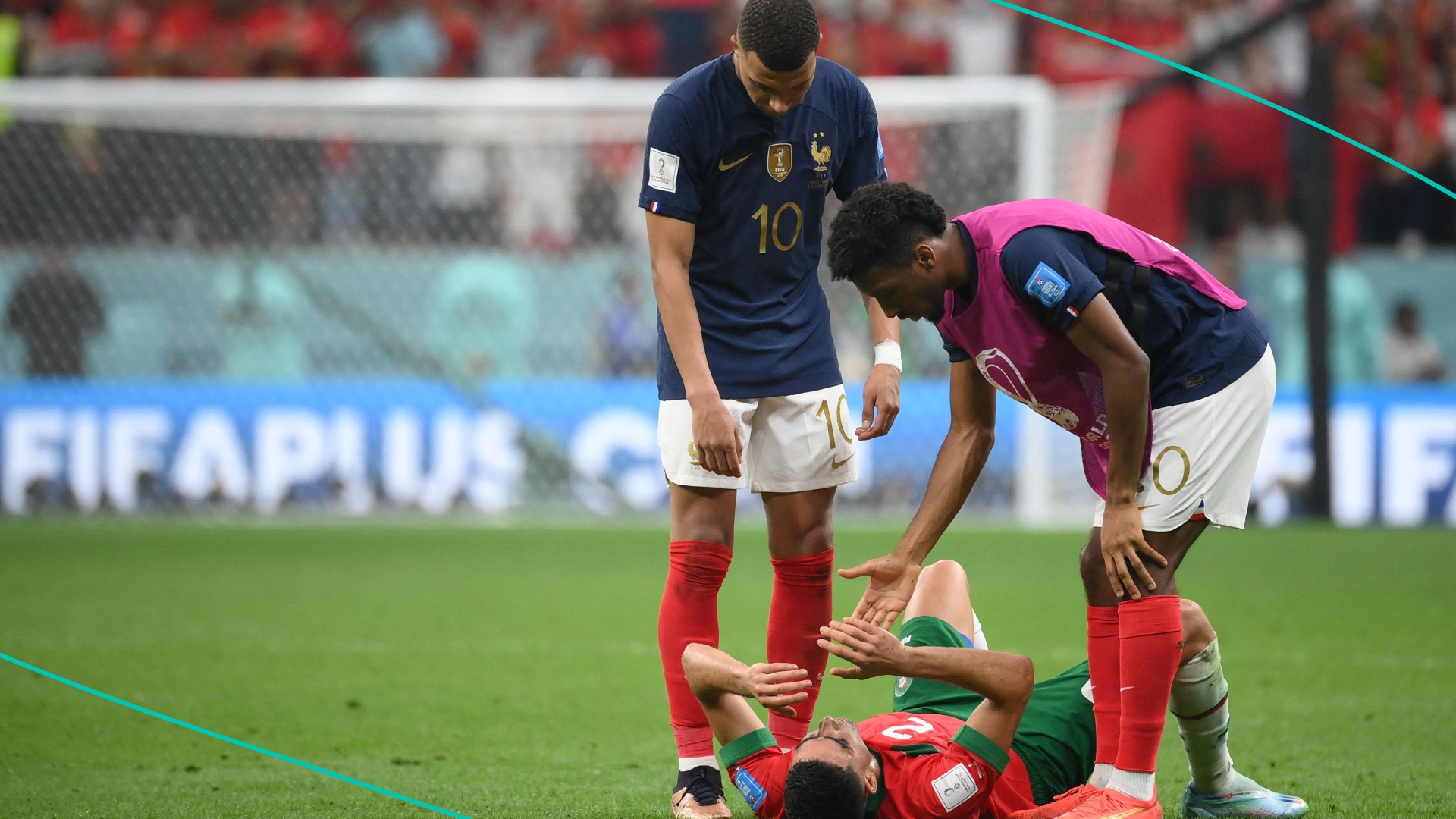France's forward #10 Kylian Mbappe and France's forward #20 Kingsley Coman comfort Morocco's defender #02 Achraf Hakimi