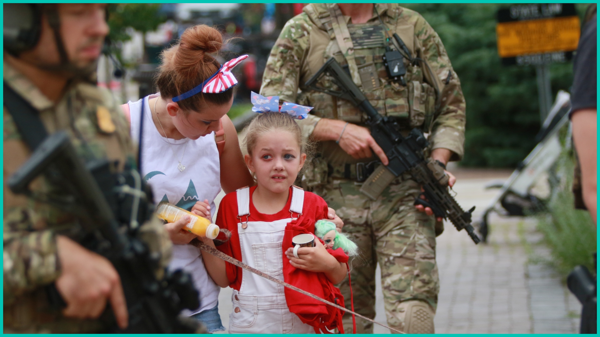Law enforcement escorts a family away from the scene of a shooting at a Fourth of July parade on July 4, 2022 in Highland Park, Illinois.