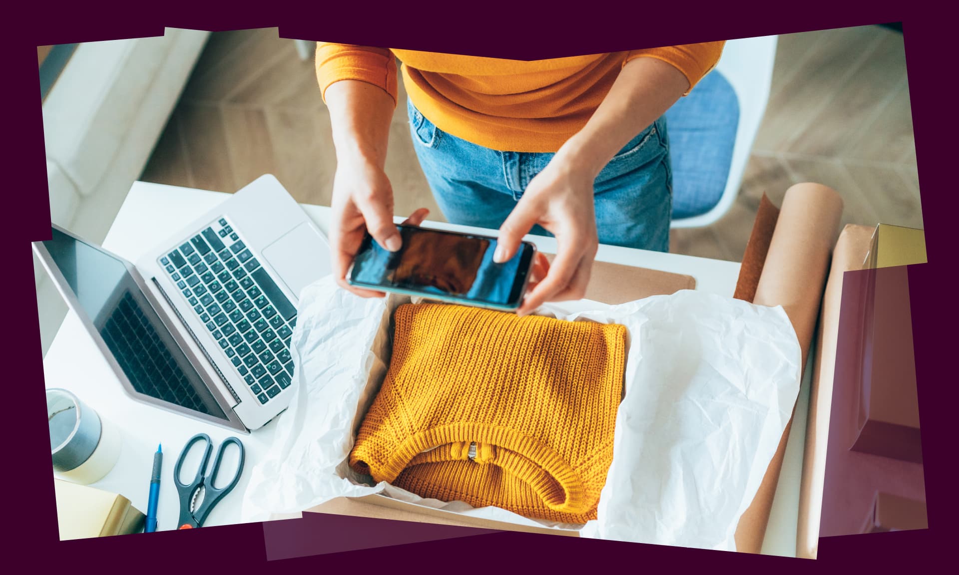 woman taking photo of sweater next to open laptop