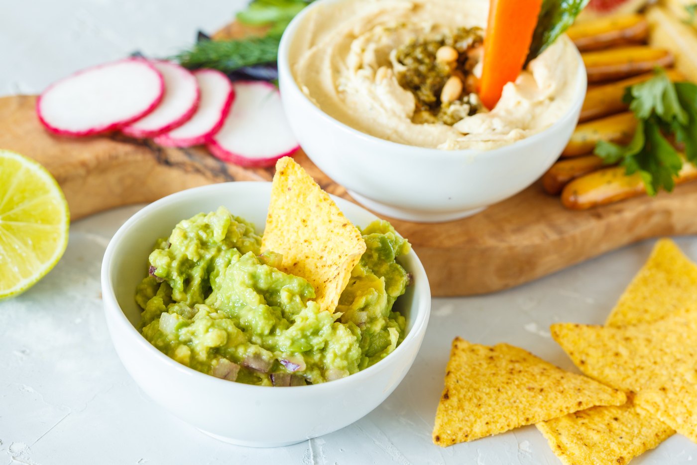 Featured image for In a battle between hummus and guac, which healthy snack dip wins?