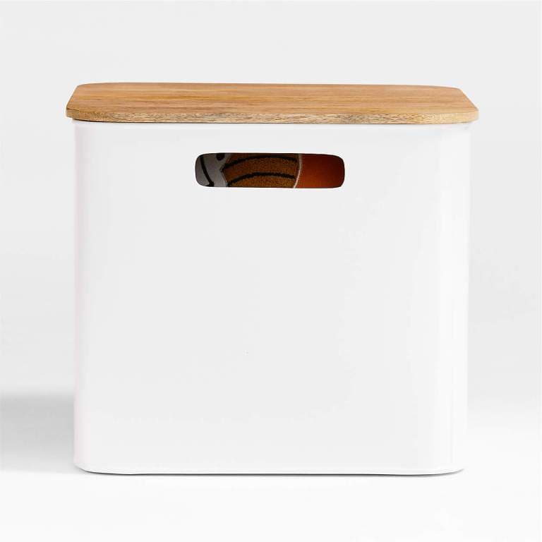 outline white large floor bin for storing at-home pilates equipment