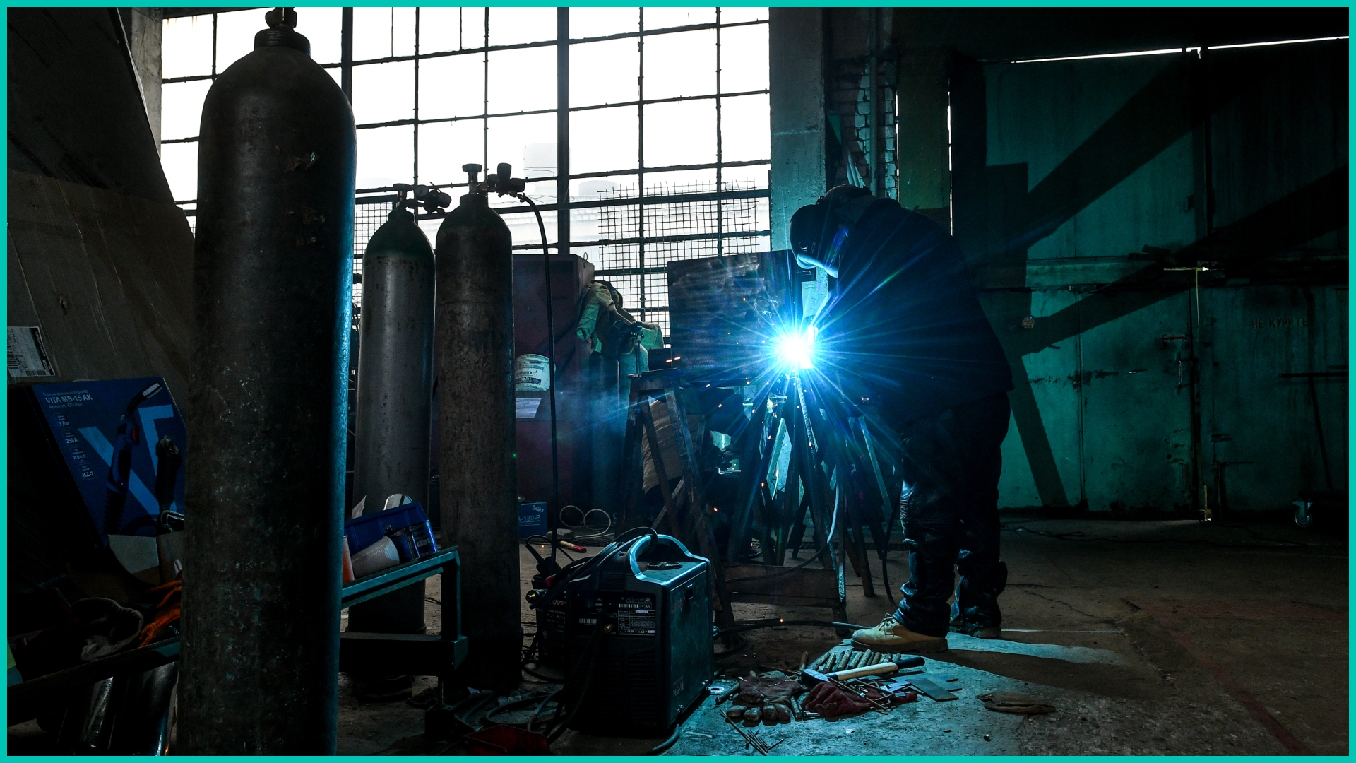 Volunteers work at a field turned into defense center where stoves, bulletproof vests, sandbags, barricades and anti-tank Czech hedgehogs being produced for the Ukrainian soldiers in Zaporizhzhia