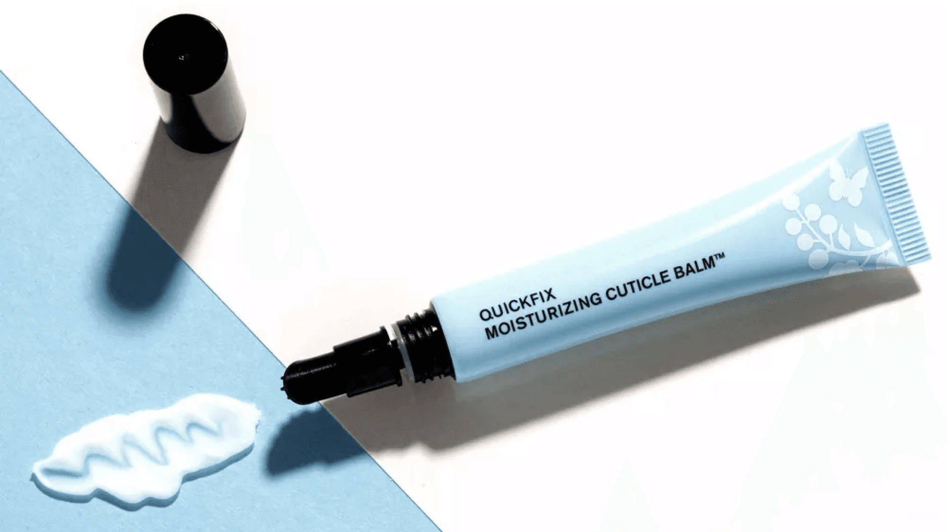 Blue tube of cuticle palm squeezed onto blue and white counter