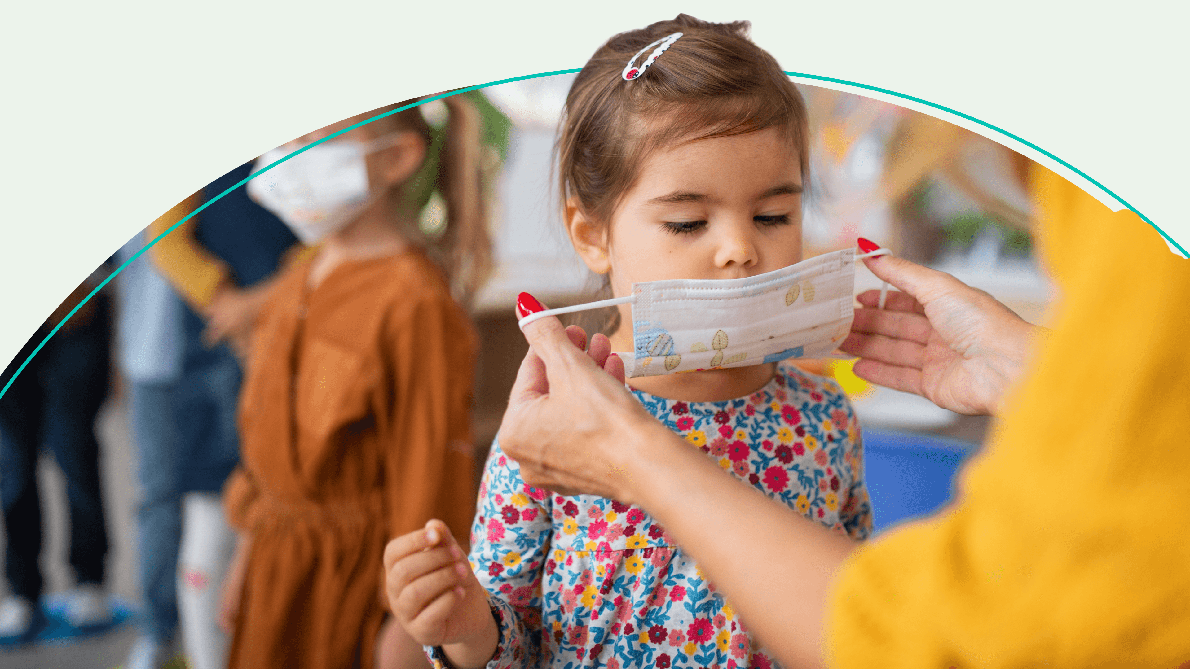 adult helps child with mask