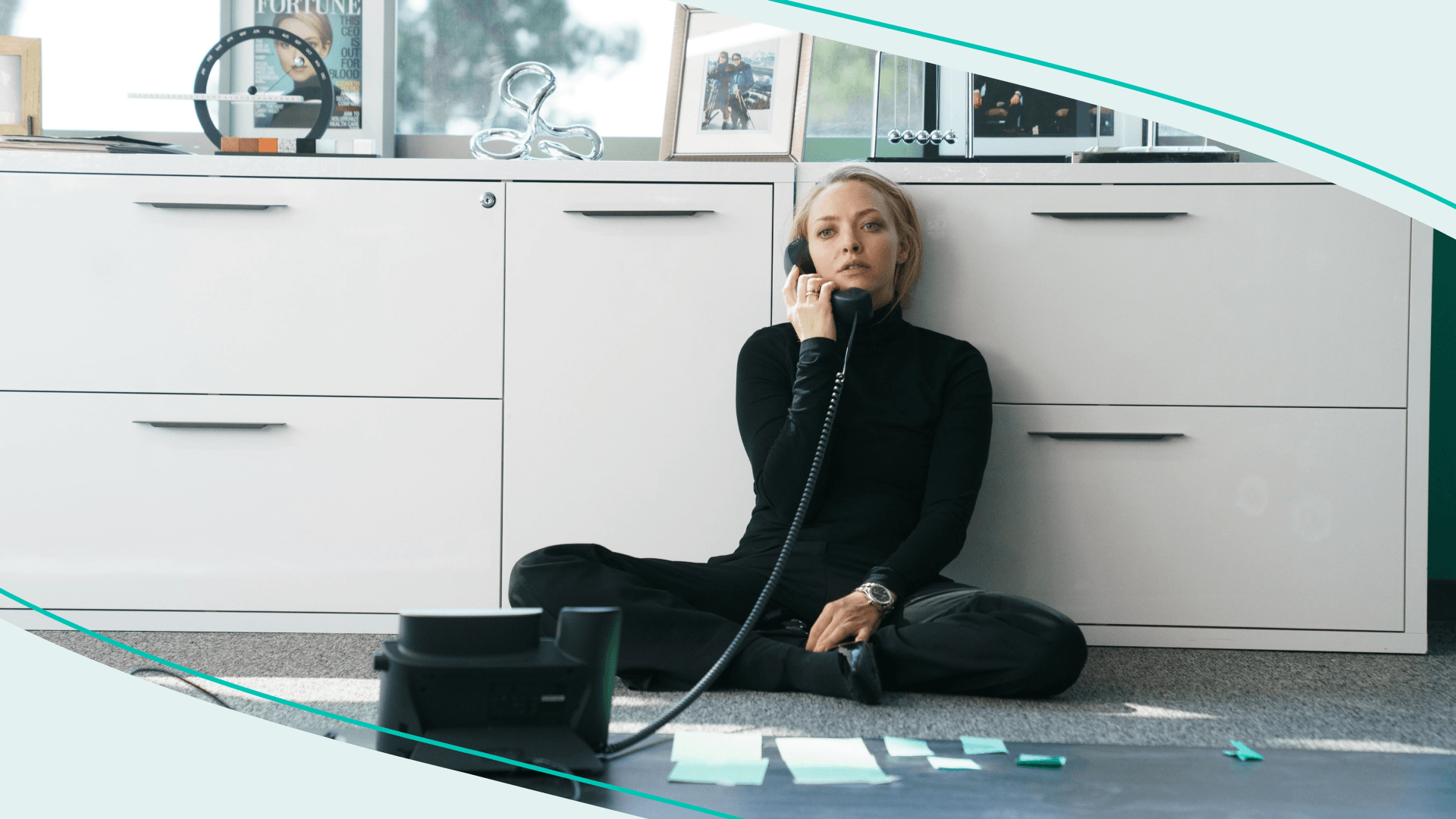 Amanda Seyfriend (portraying Elizabeth Holmes in "The Dropout") on the floor talking on the phone