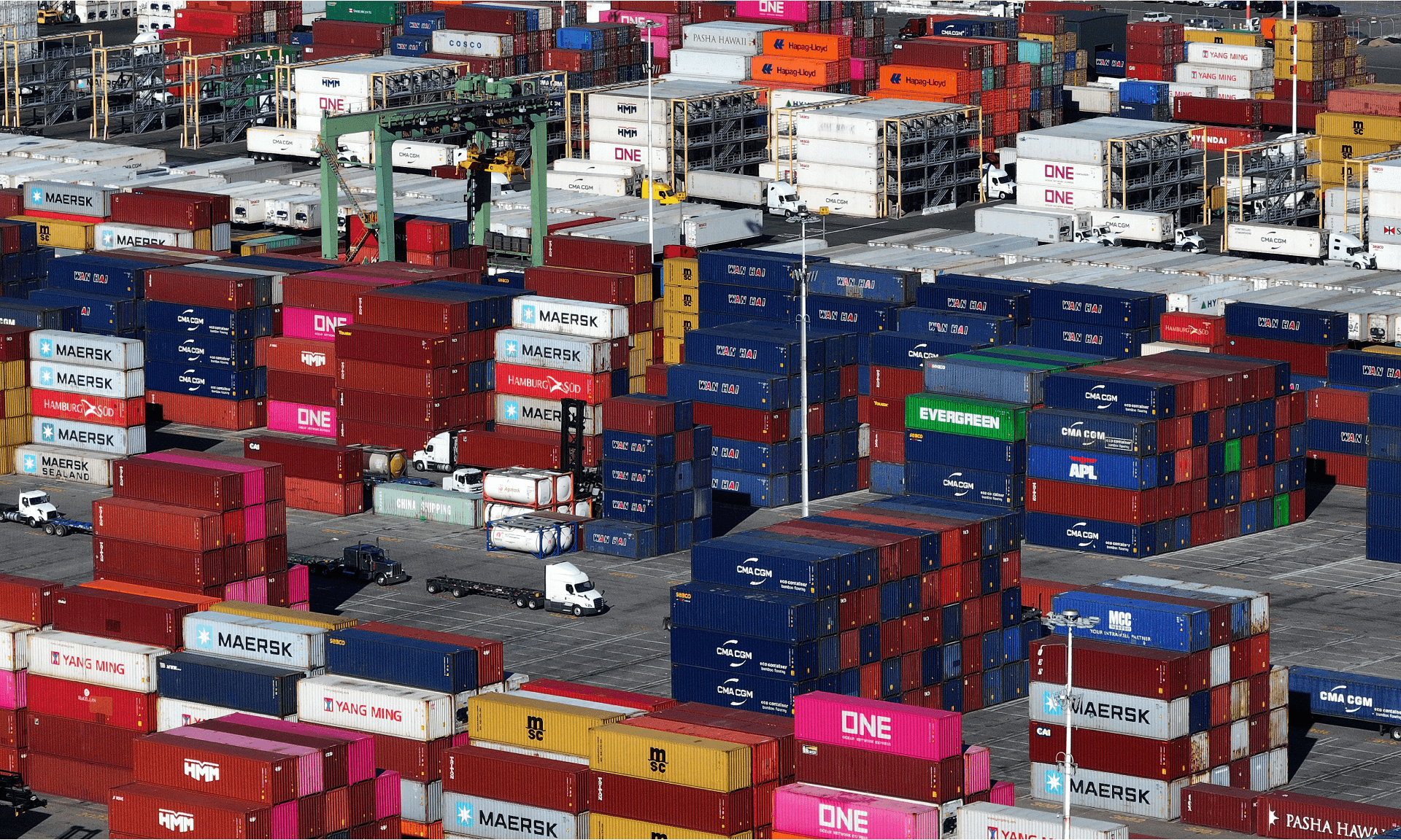 In an aerial view, shipping containers are stacked on a dock at the Port of Oakland on December 09, 2024 in Oakland, California.