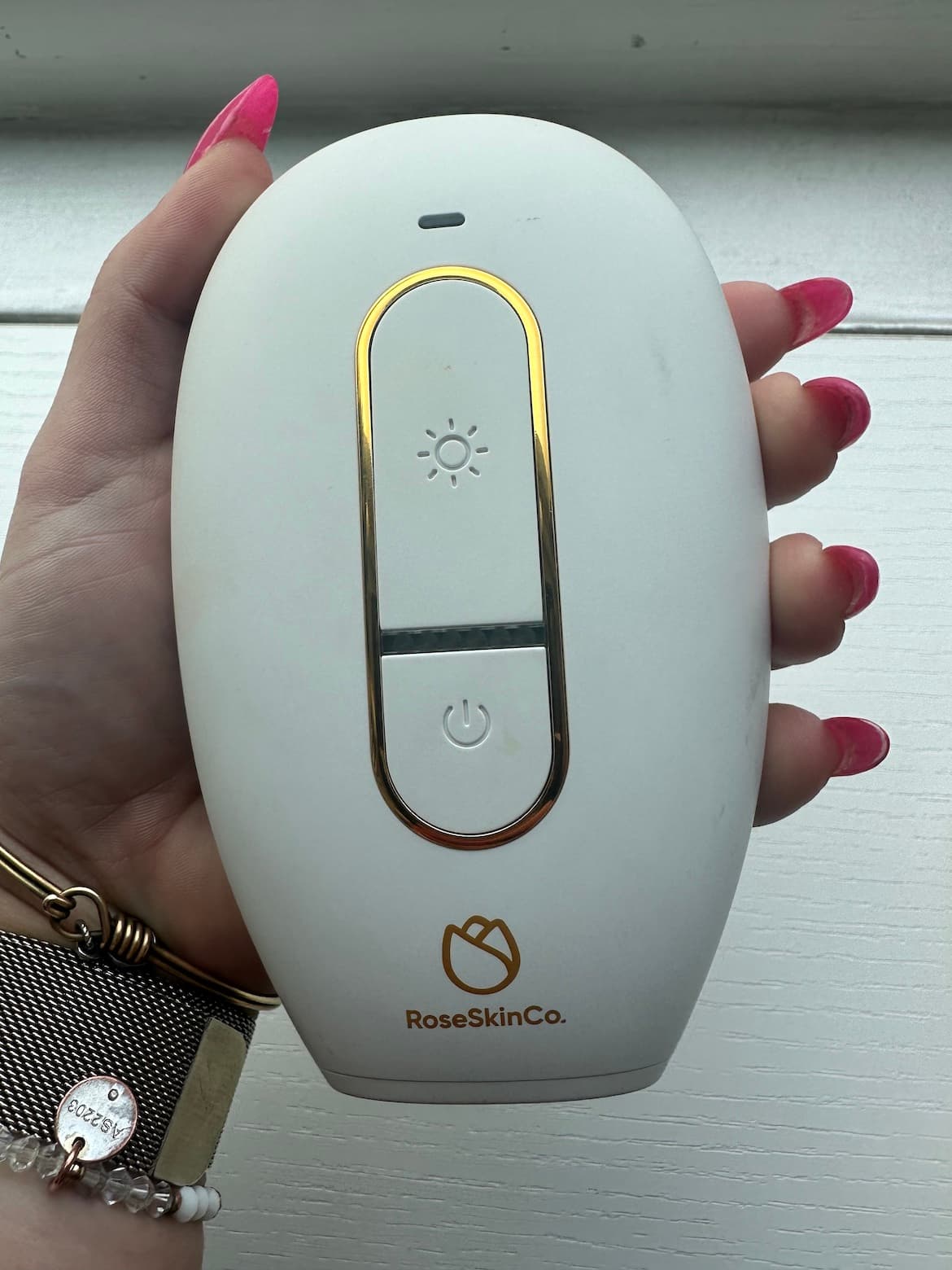 The author holding the Rose Skin Co Lumi IPL device