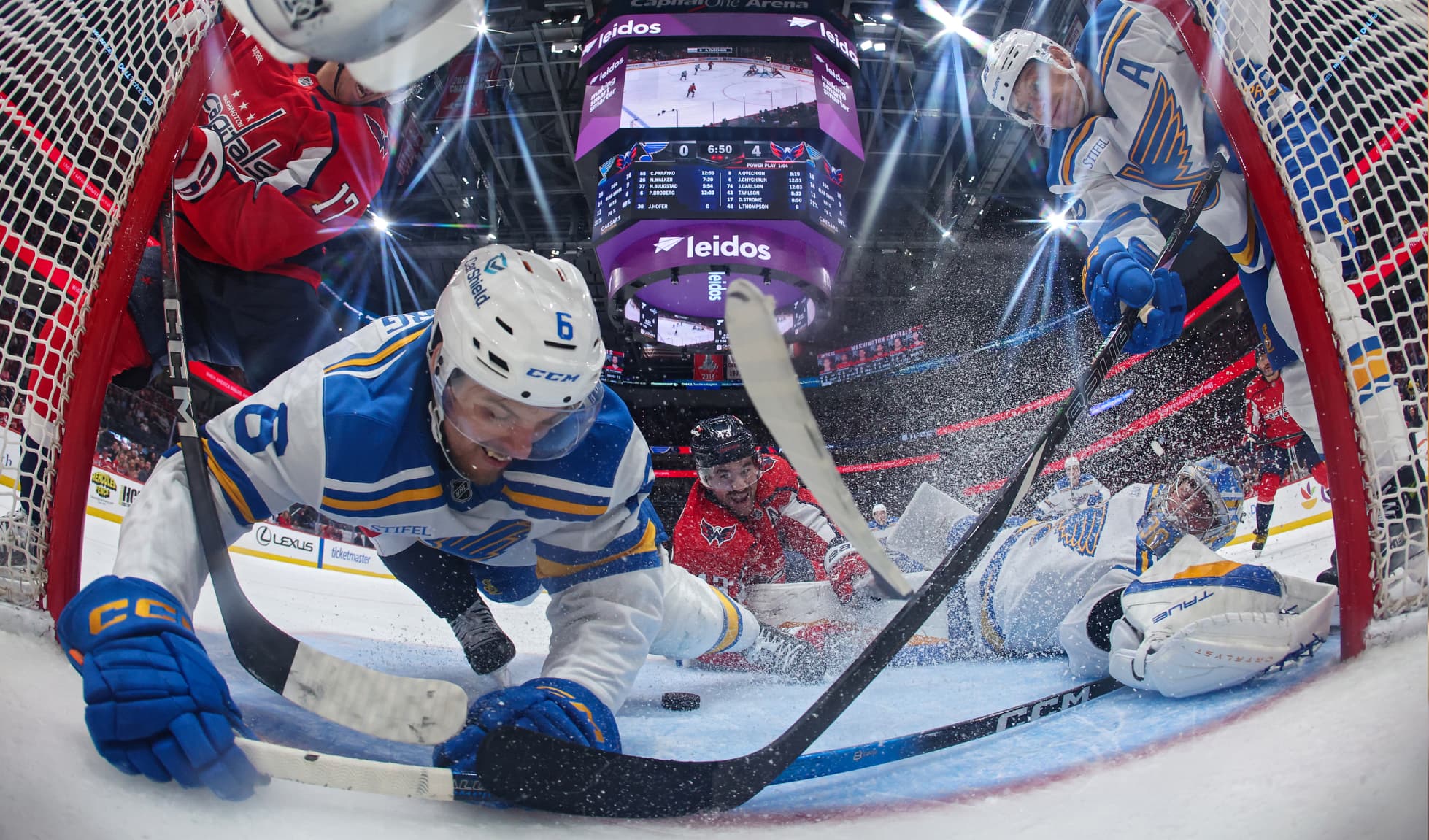 Philip Broberg #6 of the St. Louis Blues and goalie Joel Hofer #30 of the St. Louis Blues stop the puck from going over the goal line