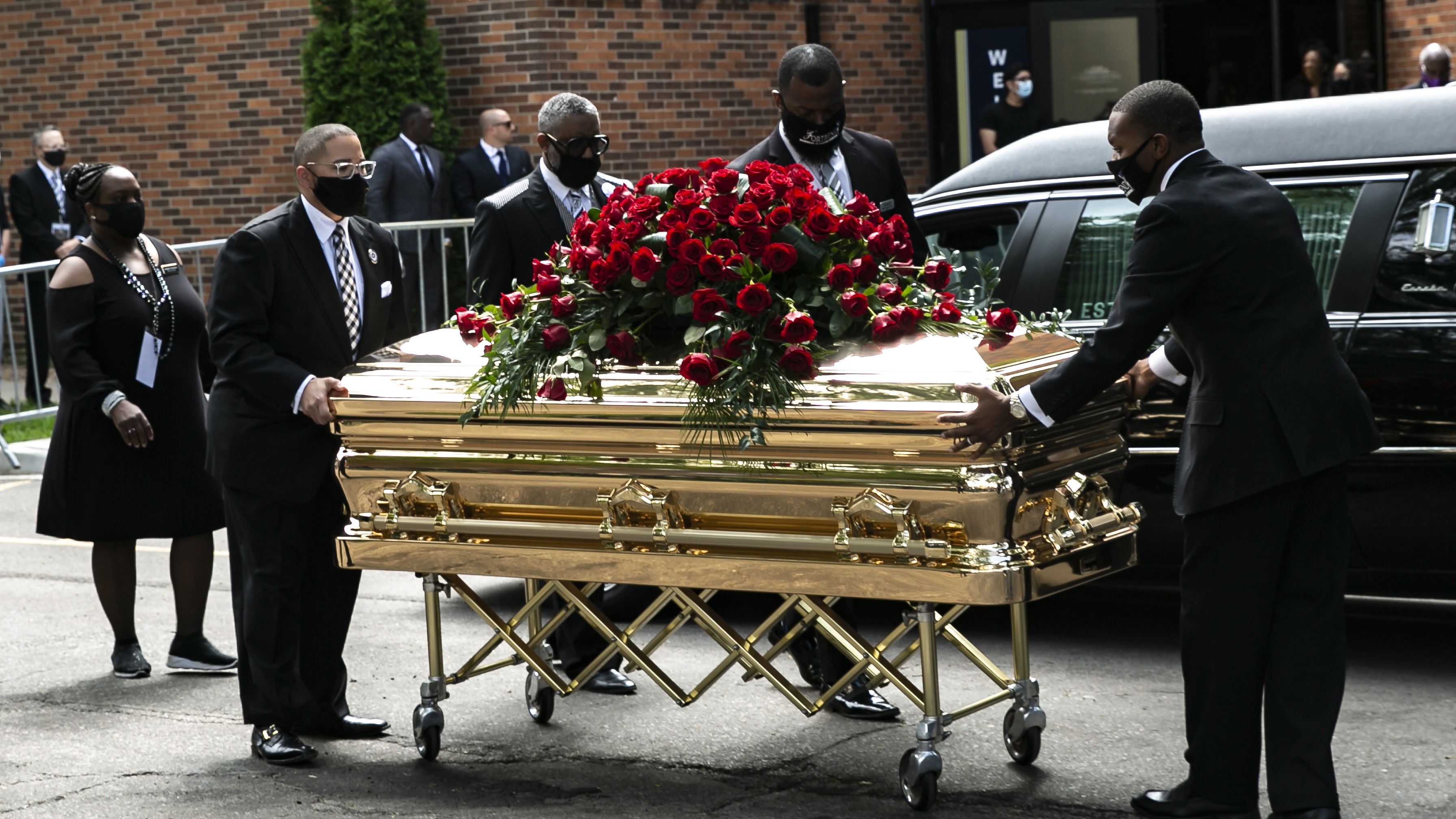 George Floyd's casket is wheeled to a hearse.