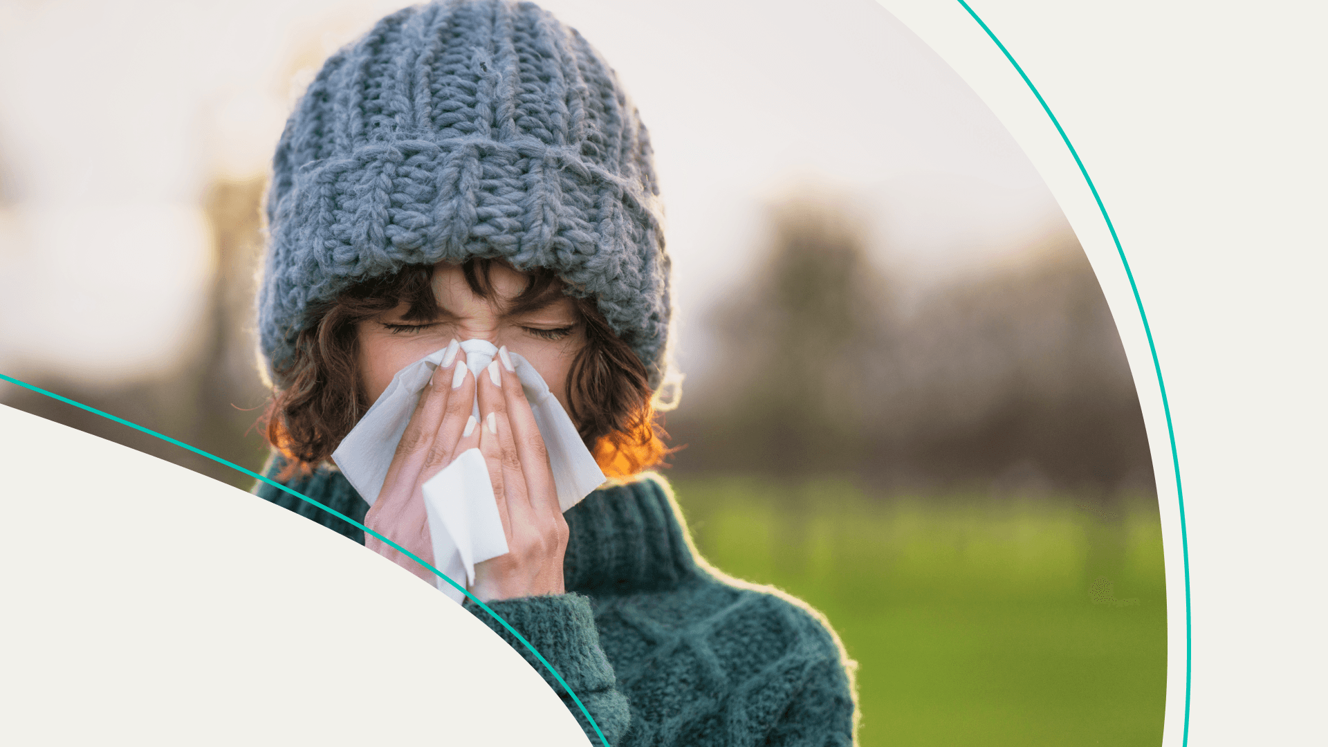 A woman in a knit beanie blows her nose with a tissue.