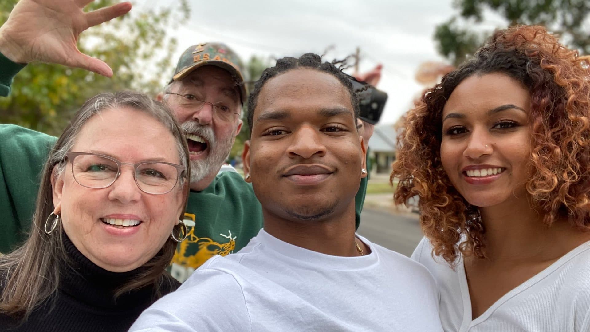 Jamal Hinton celebrating Thanksgiving in 2021 with his girlfriend, Wanda Dench, and Dench’s husband.