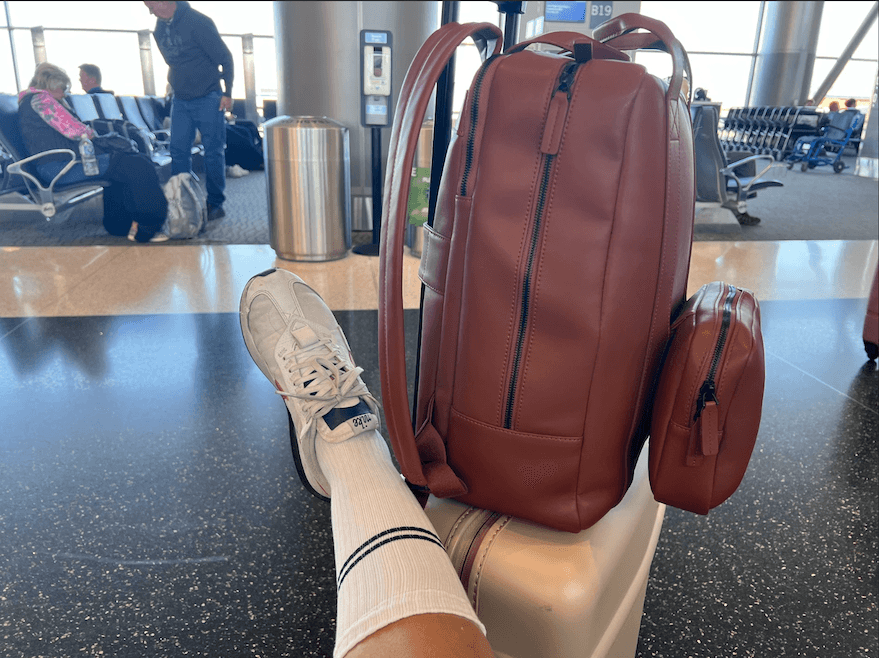 Closeup of legs in Bombas Everyday Compression Socks and a backpack