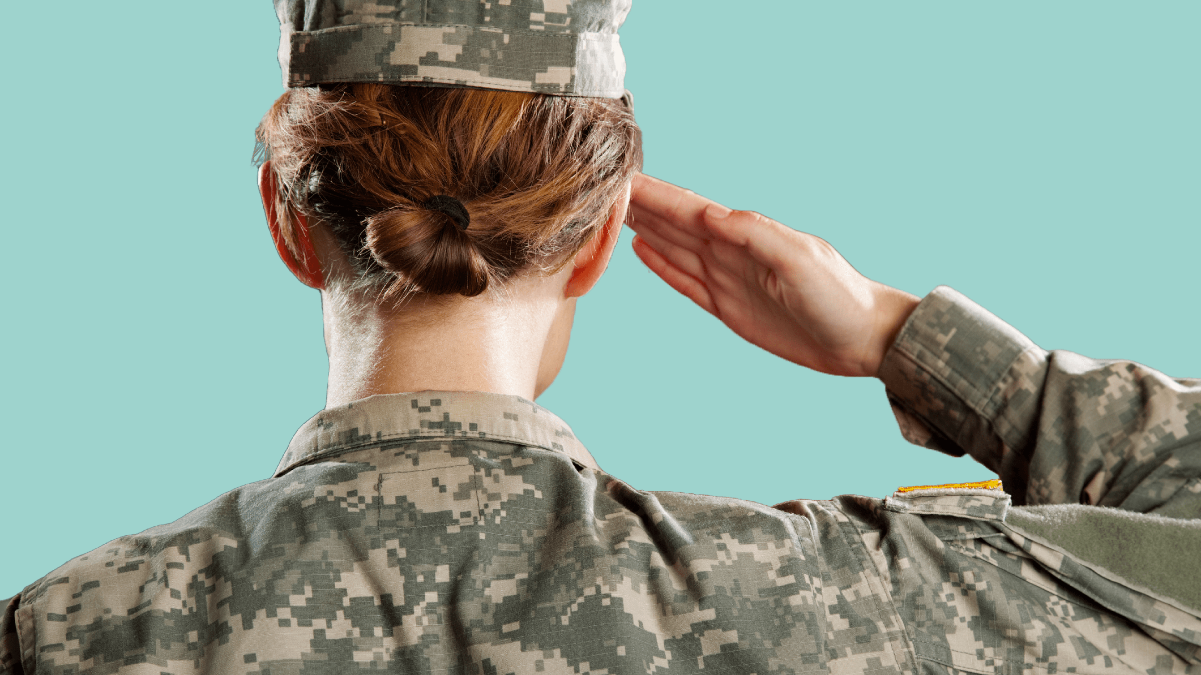 Woman in military gear saluting
