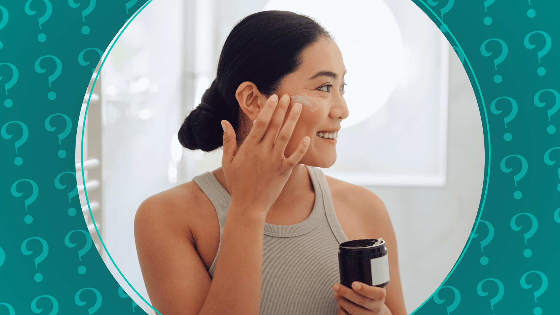A woman applying cream to her face