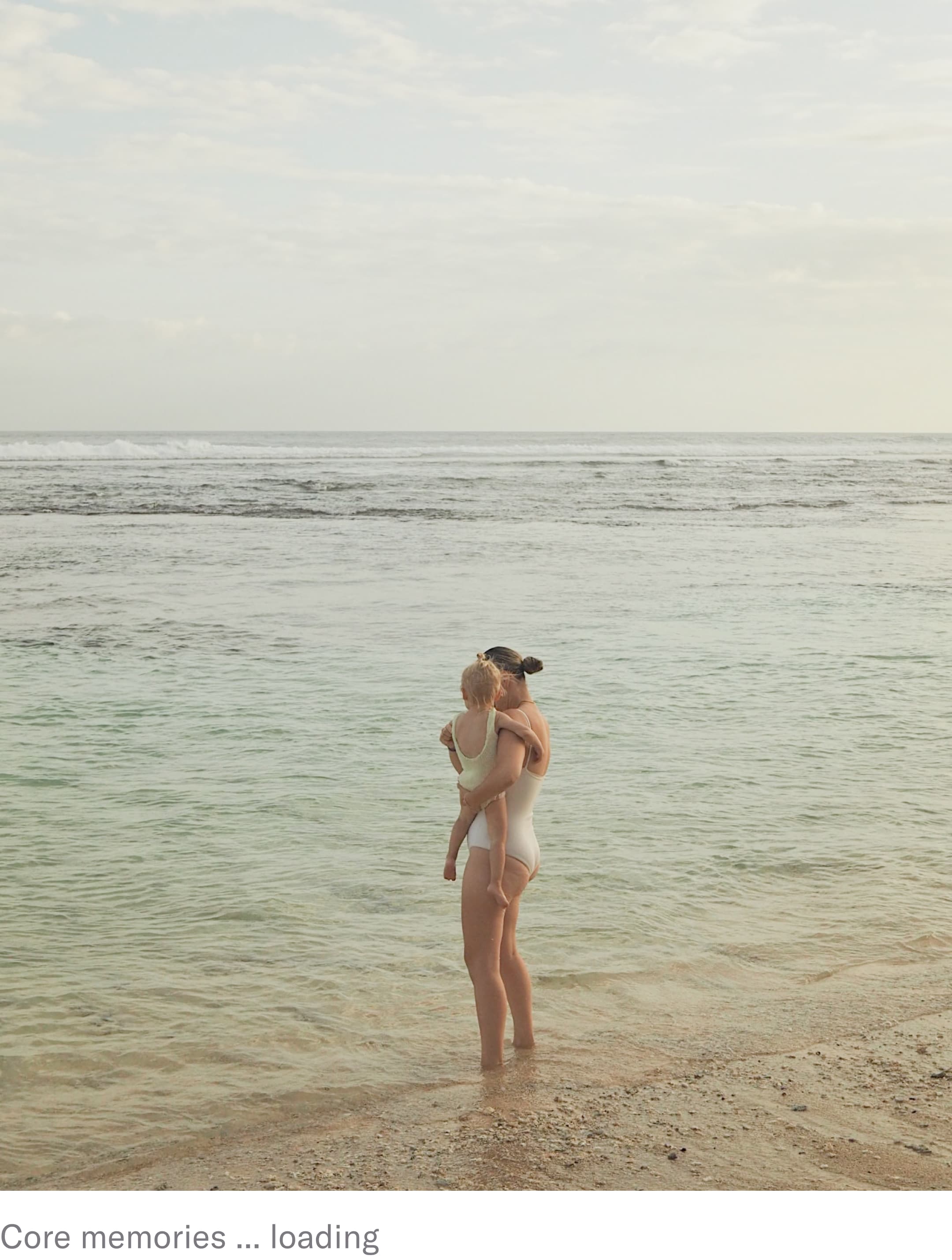 woman and baby on beach